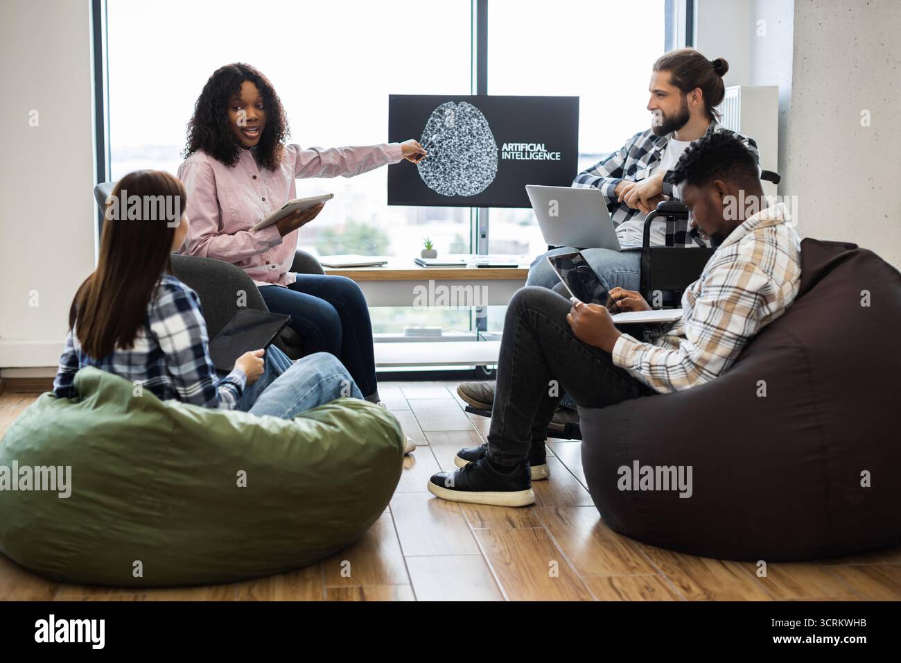Team collaborating on artificial intelligence project in office Stock Photo