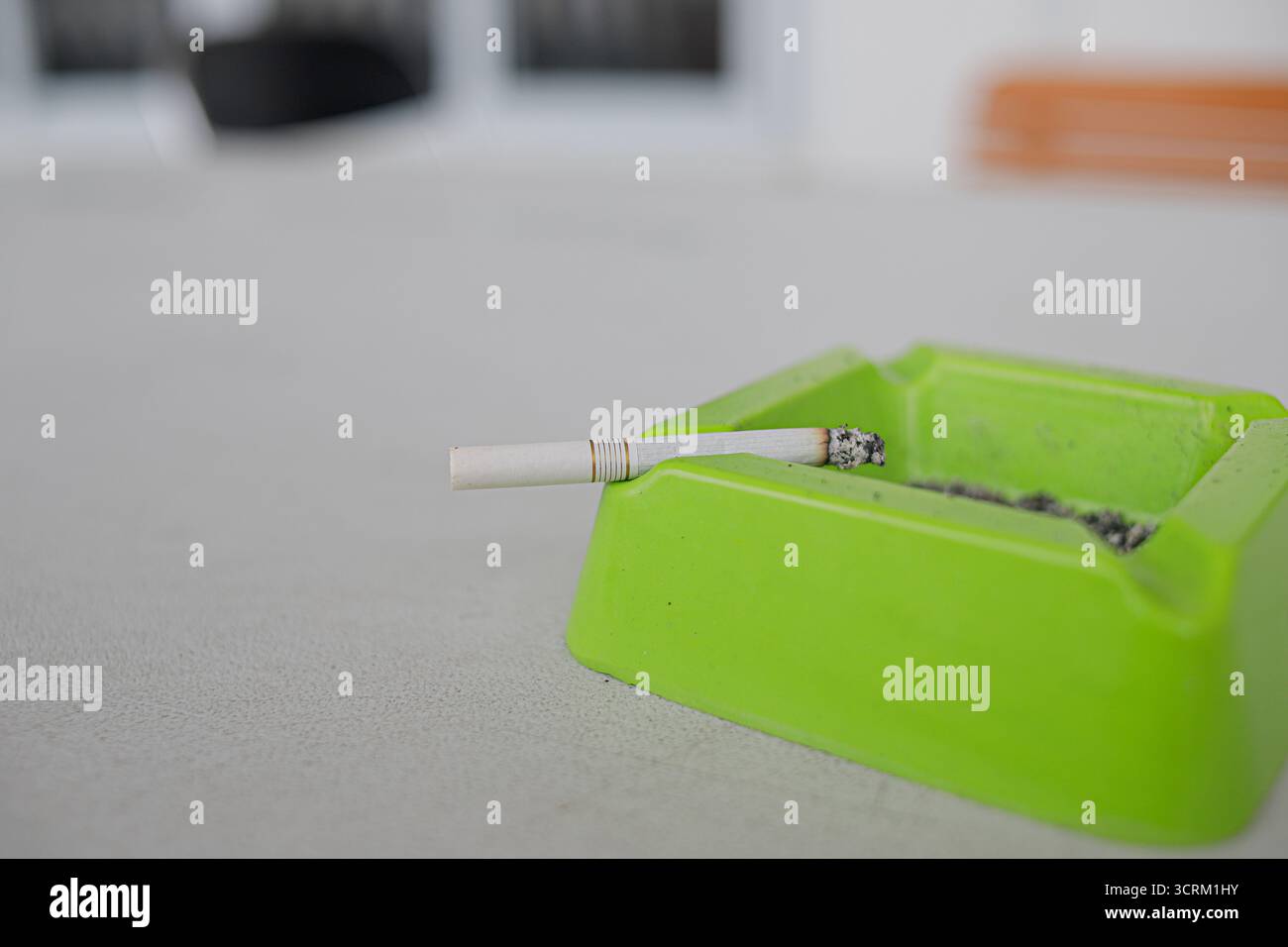 Lighting cigarette in ashtray isolated on white background Stock Photo