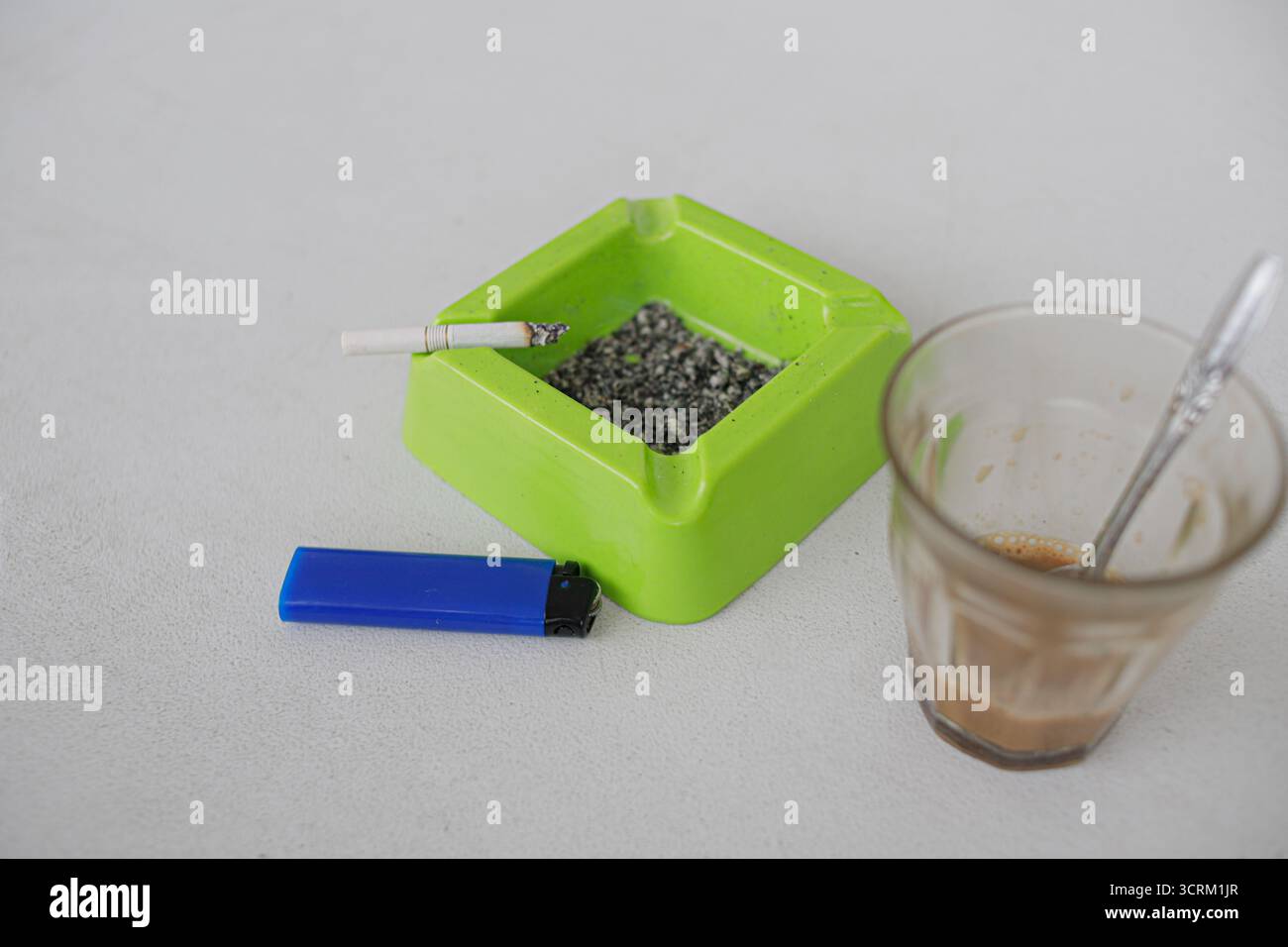 Lighting cigarette in ashtray isolated on white background Stock Photo