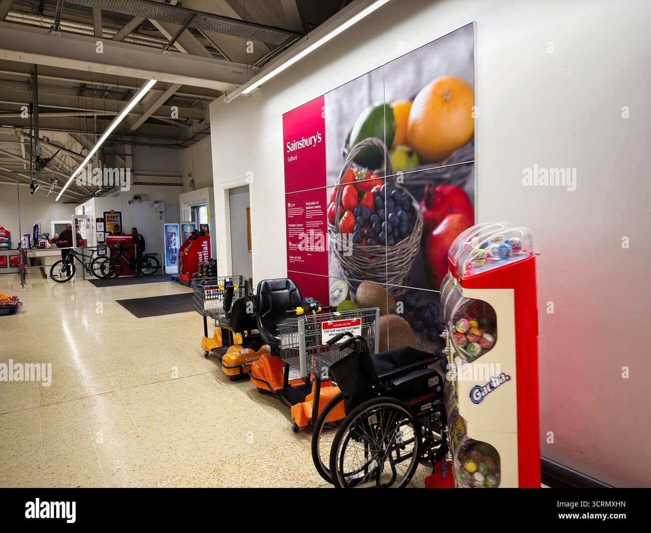 Salford, UK - September 25, 2025: Bright store aisle with fruit mural ...
