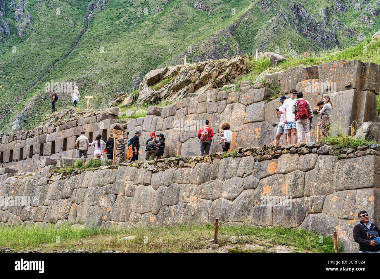 Cusco, Peru - March 17, 2025: Tourists exploring Ollantaytambo Archaeological Site, a major Inca ruin and popular attraction in the Sacred Valley Stock Photo