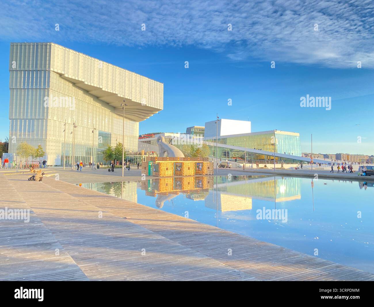 The late autumn sun lights up the ÔDeichman Bj¿rvikaÕ new main library facing the waterfront and harbour. Next door is also the modern Oslo Opera Hous - Smartphone Captured Stock Image