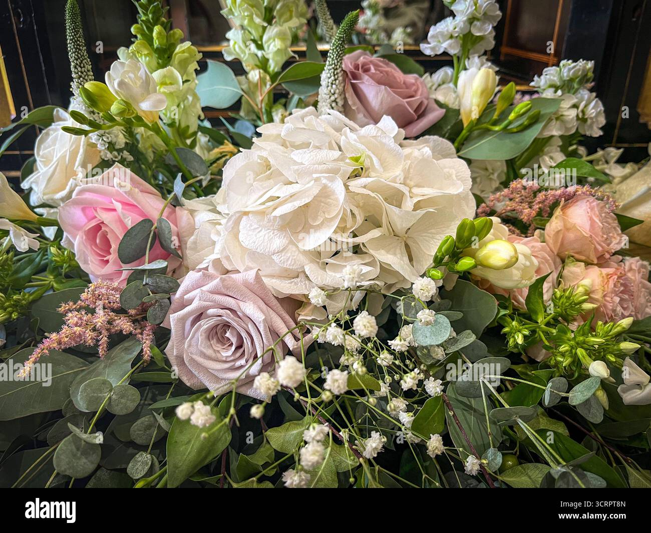 An elegant arrangement of diverse flowers, designed as a wedding bouquet or as a refined floral composition for a special celebration or event. - Smartphone Captured Stock Image
