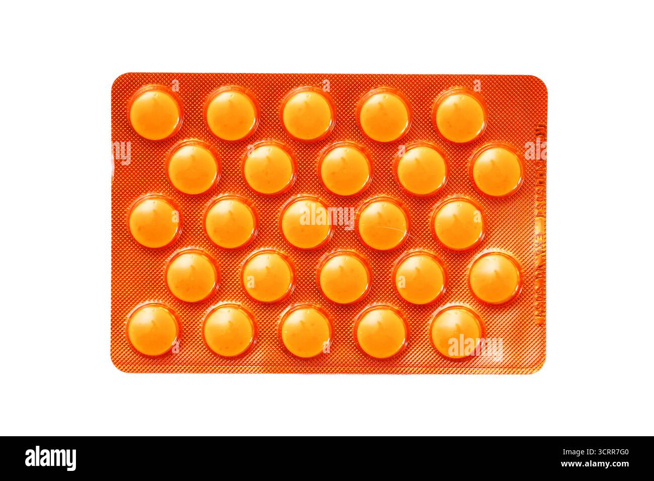 Orange blister pack with round pills. Medical tablets and pharmacy product on white background. Health and wellness concept. Vitamin and medication. Stock Photo