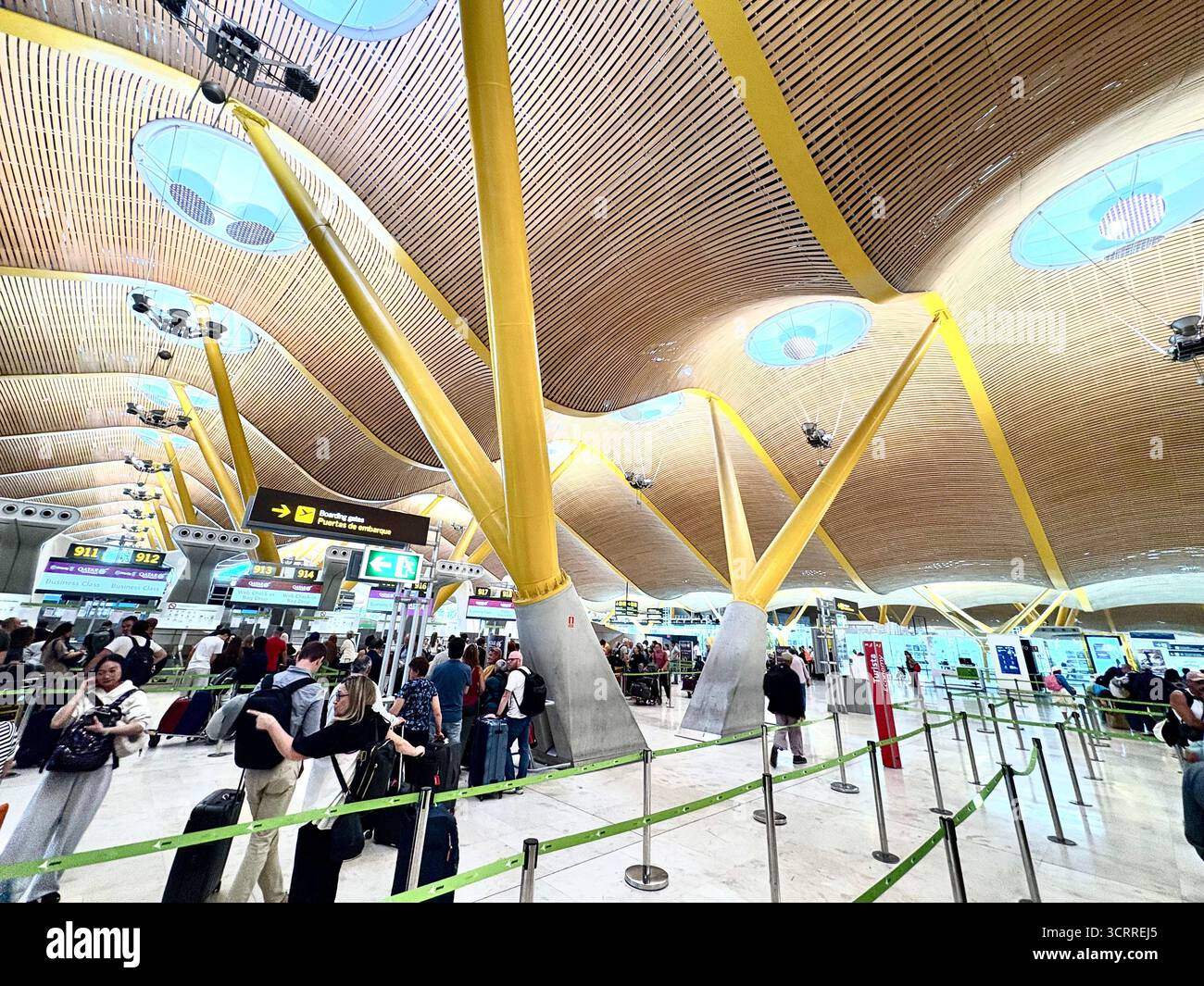 Madrid international airport, terminal 4S, passengers queue to check in for their flight with Qatar Airways,Spain,Europe - Smartphone Captured Stock Image