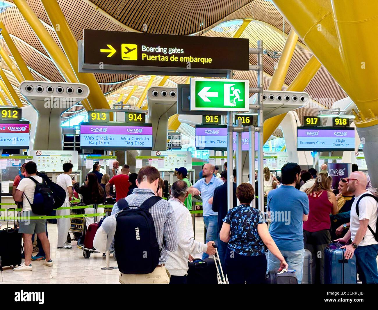 Madrid international airport, terminal 4S, passengers queue to check in for their flight with Qatar Airways,Spain,Europe - Smartphone Captured Stock Image