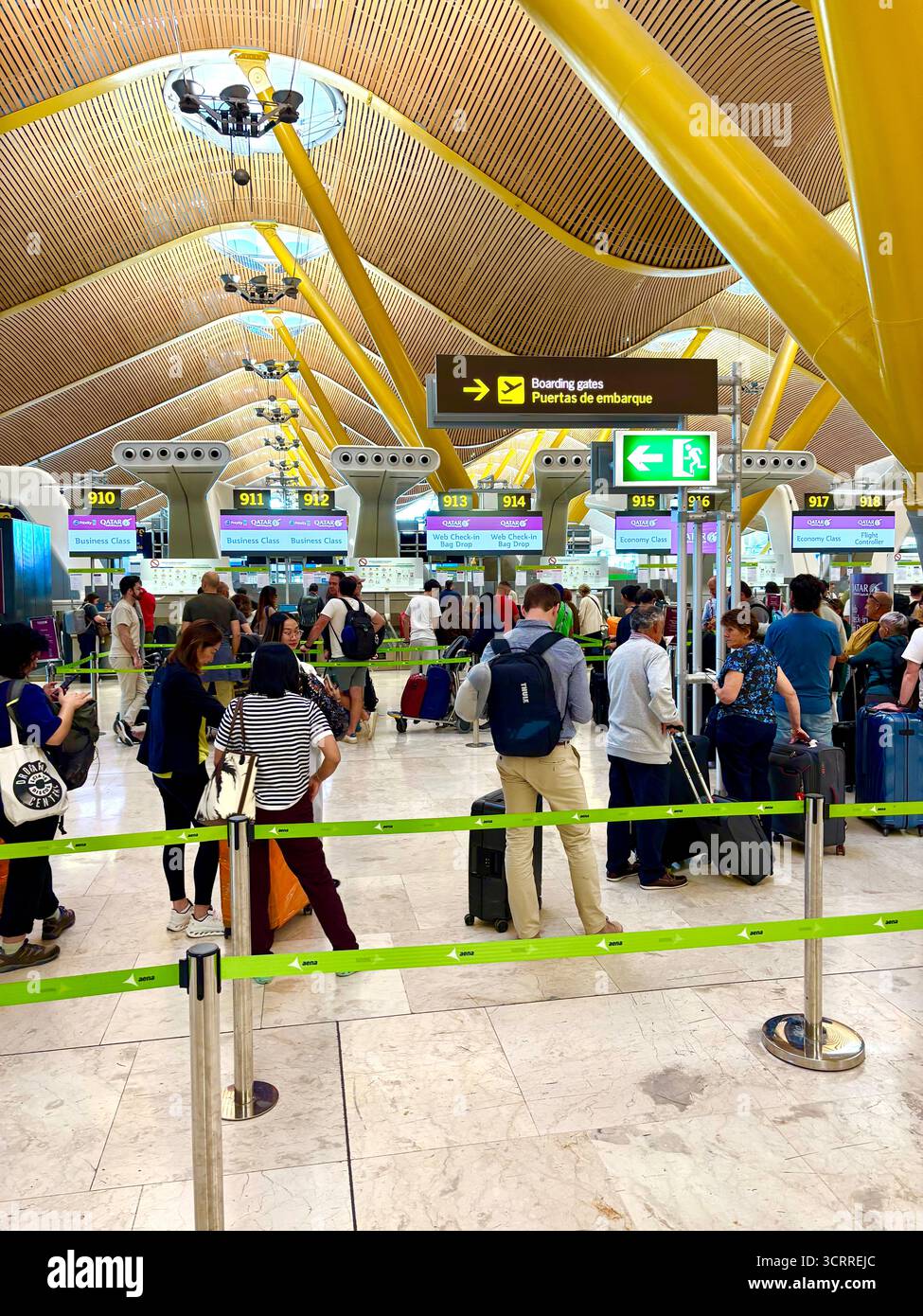 Madrid international airport, terminal 4S, passengers queue to check in for their flight with Qatar Airways,Spain,Europe - Smartphone Captured Stock Image
