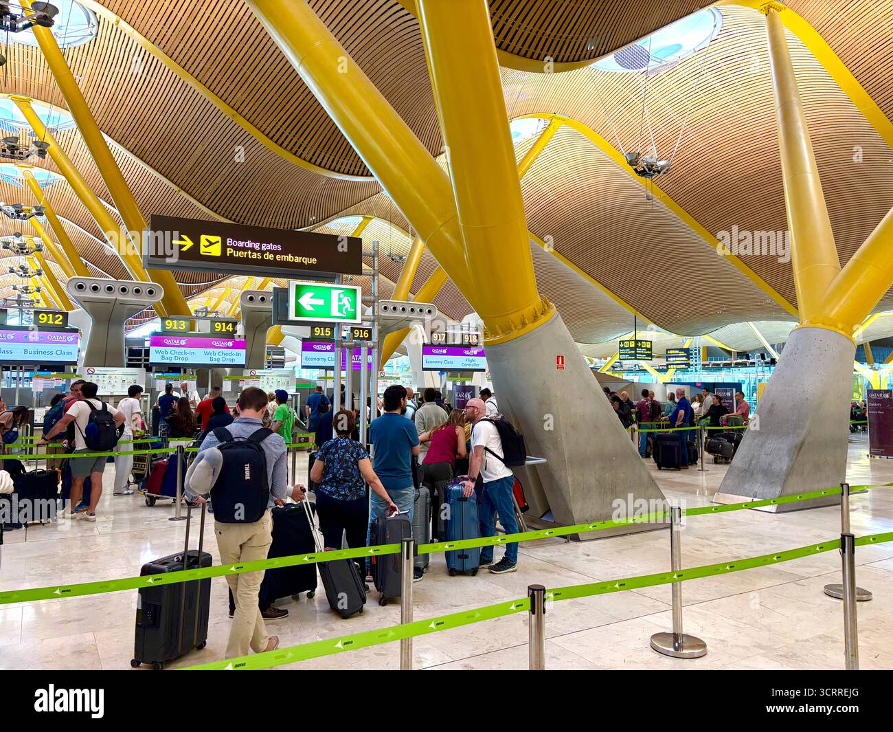 Madrid international airport, terminal 4S, passengers queue to check in for their flight with Qatar Airways,Spain,Europe - Smartphone Captured Stock Image