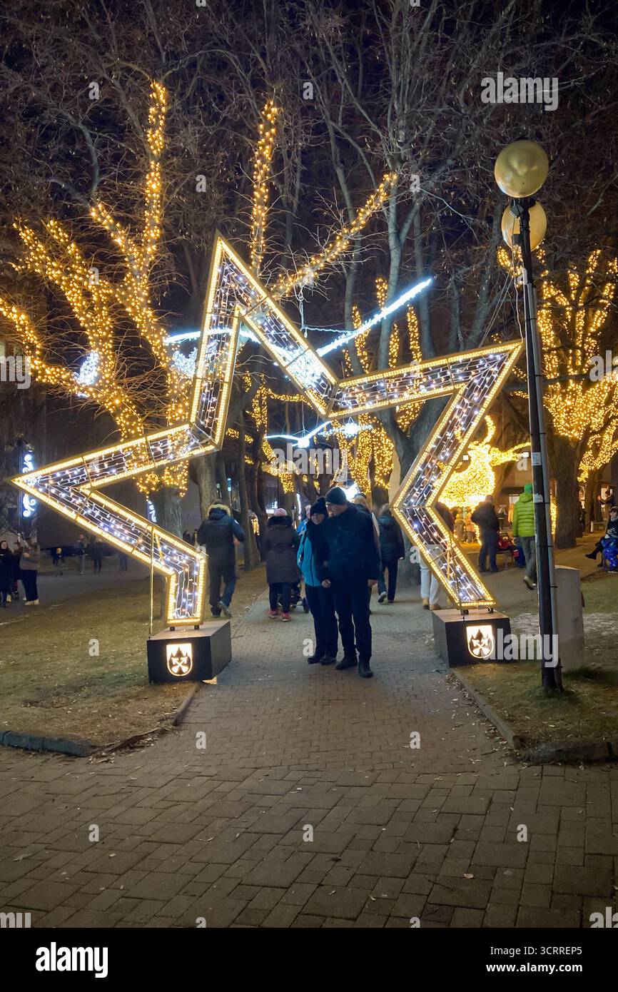 SLOVAKIA, POPRAD - DECEMBER 29, 2024: The city center of Poprad glows with a magical Christmas atmosphere, featuring festive lights, decorated trees, - Smartphone Captured Stock Image