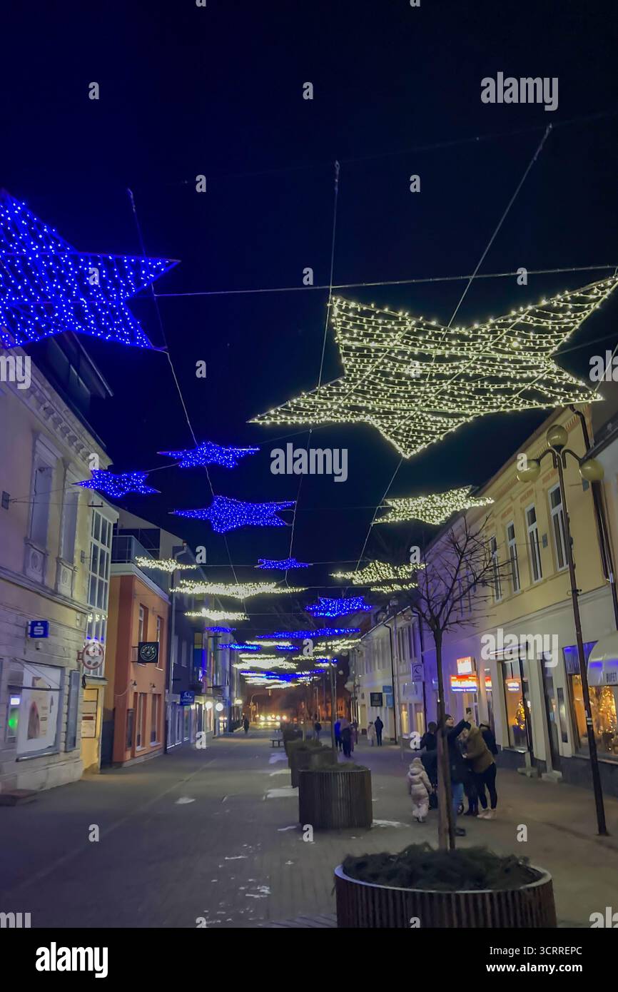 SLOVAKIA, POPRAD - DECEMBER 29, 2024: The city center of Poprad glows with a magical Christmas atmosphere, featuring festive lights, decorated trees, - Smartphone Captured Stock Image