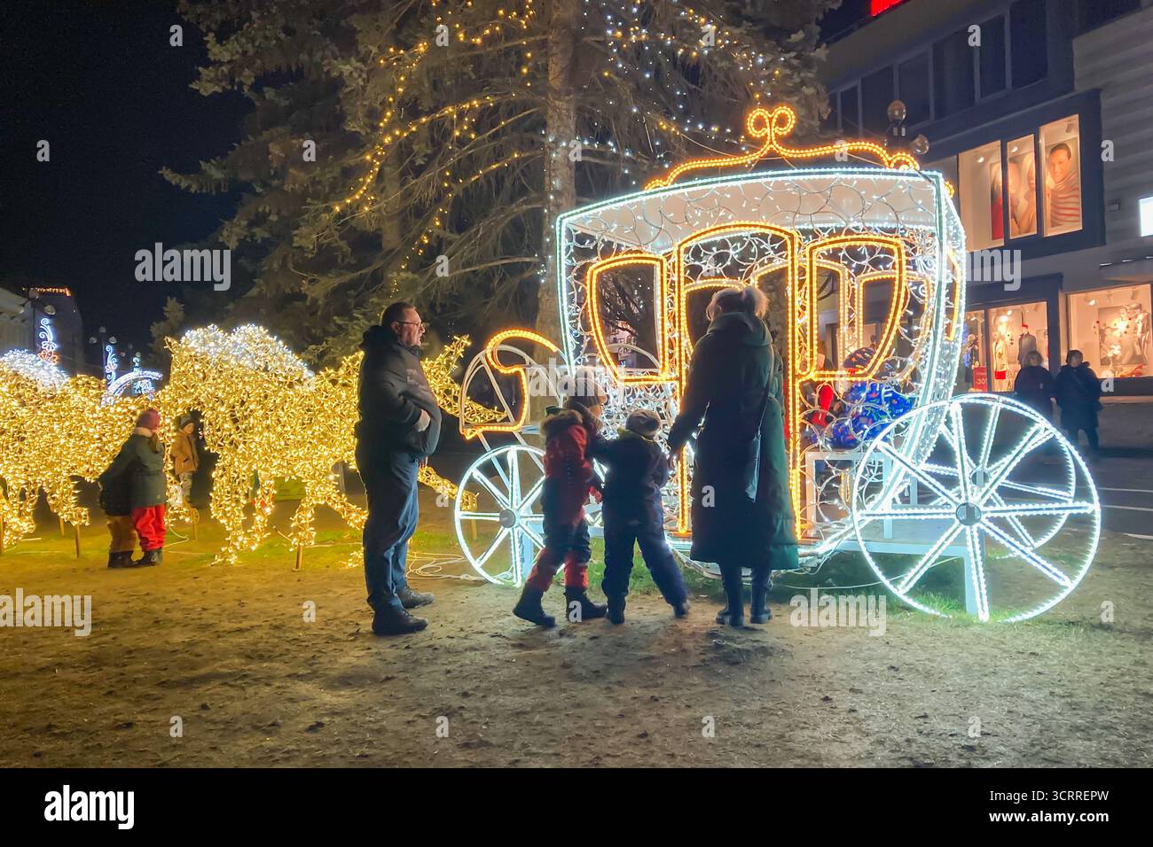 SLOVAKIA, POPRAD - DECEMBER 29, 2024: The city center of Poprad glows with a magical Christmas atmosphere, featuring festive lights, decorated trees, - Smartphone Captured Stock Image