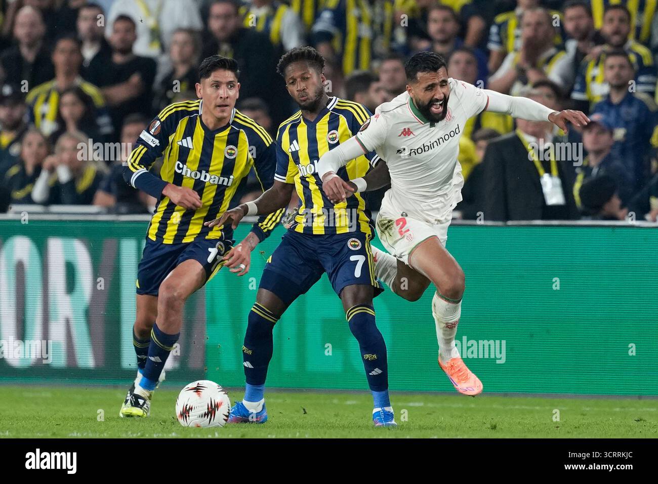 Nice's Ali Abdi, right, fights for the ball with Fenerbahce's Fred ...