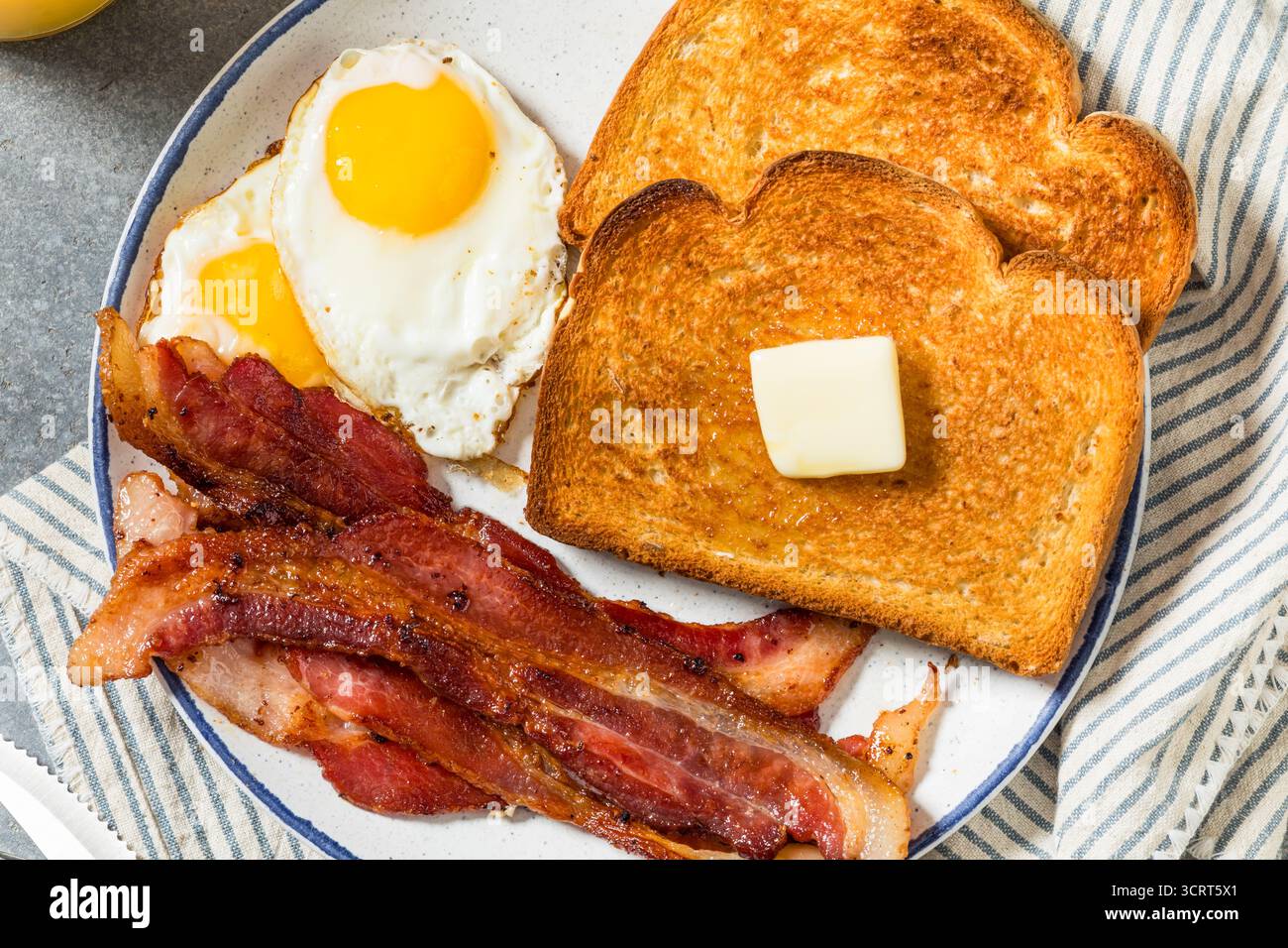 Healthy American Bacon Egg and Toast Breakfast with Orange Juice Stock Photo