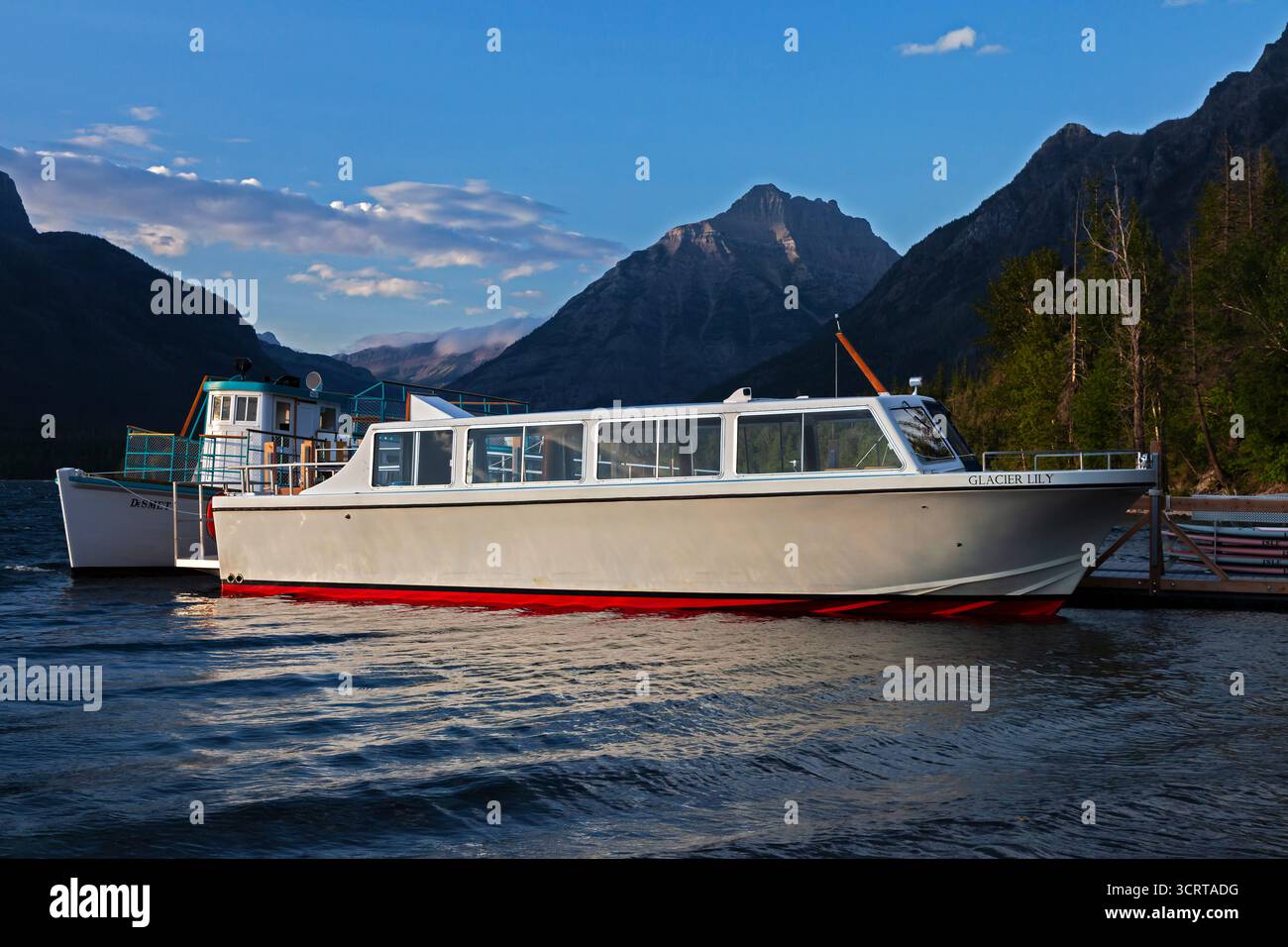 The Glacier Park Boat Company's vessels Glacier Lily and Desmet rests at the Lake McDonald Lodge boat bock. Built in 1930 the Desmet is on the Nationa Stock Photo
