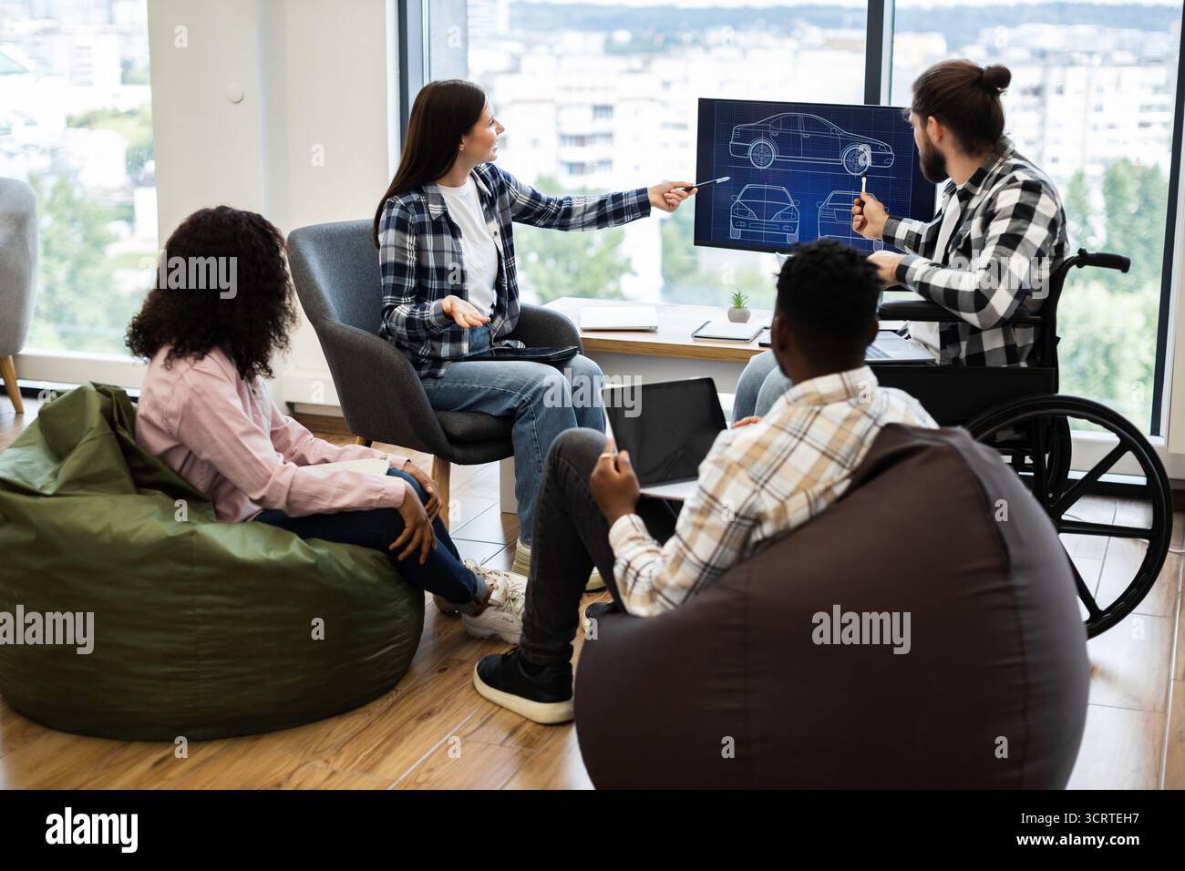Team brainstorming car design ideas using modern technology Stock Photo