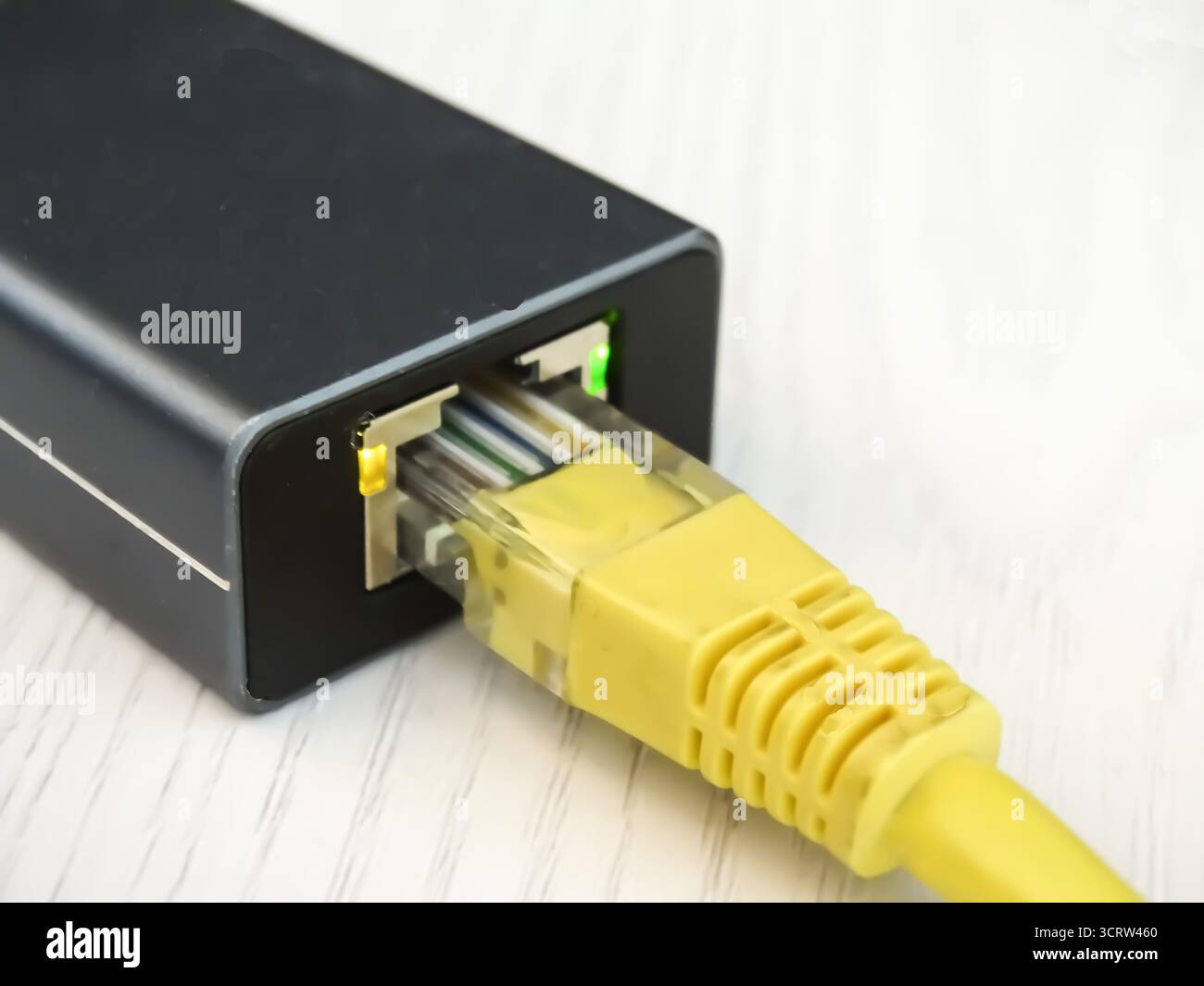 Internet cable connected to a multi-functional USB-C Hub station, Ethernet Stock Photo
