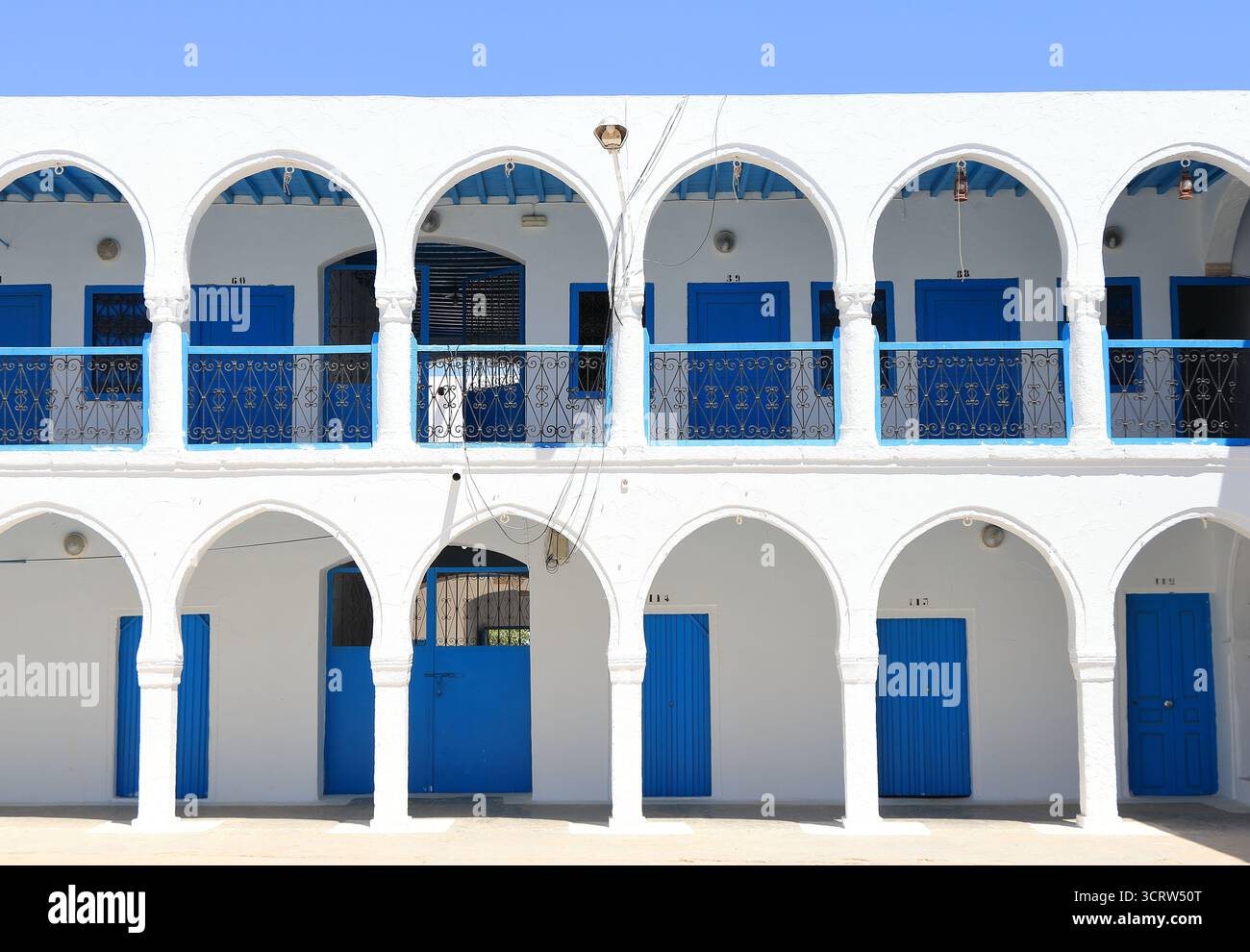 White Arched Building Facade with Blue Doors in Djerba, Tunisia Stock ...