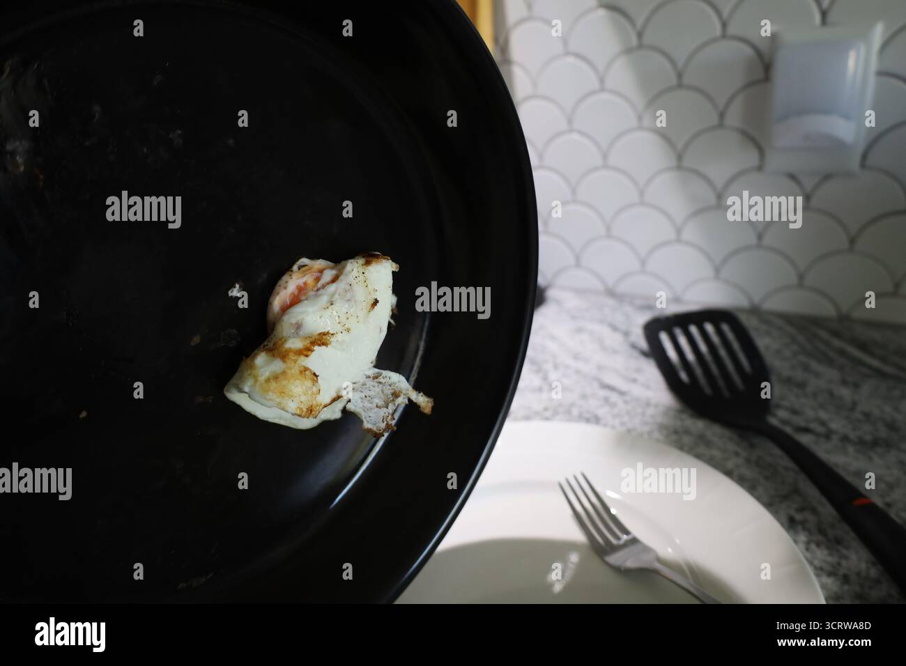 Fried Egg in Black Skillet Over Countertop Stock Photo