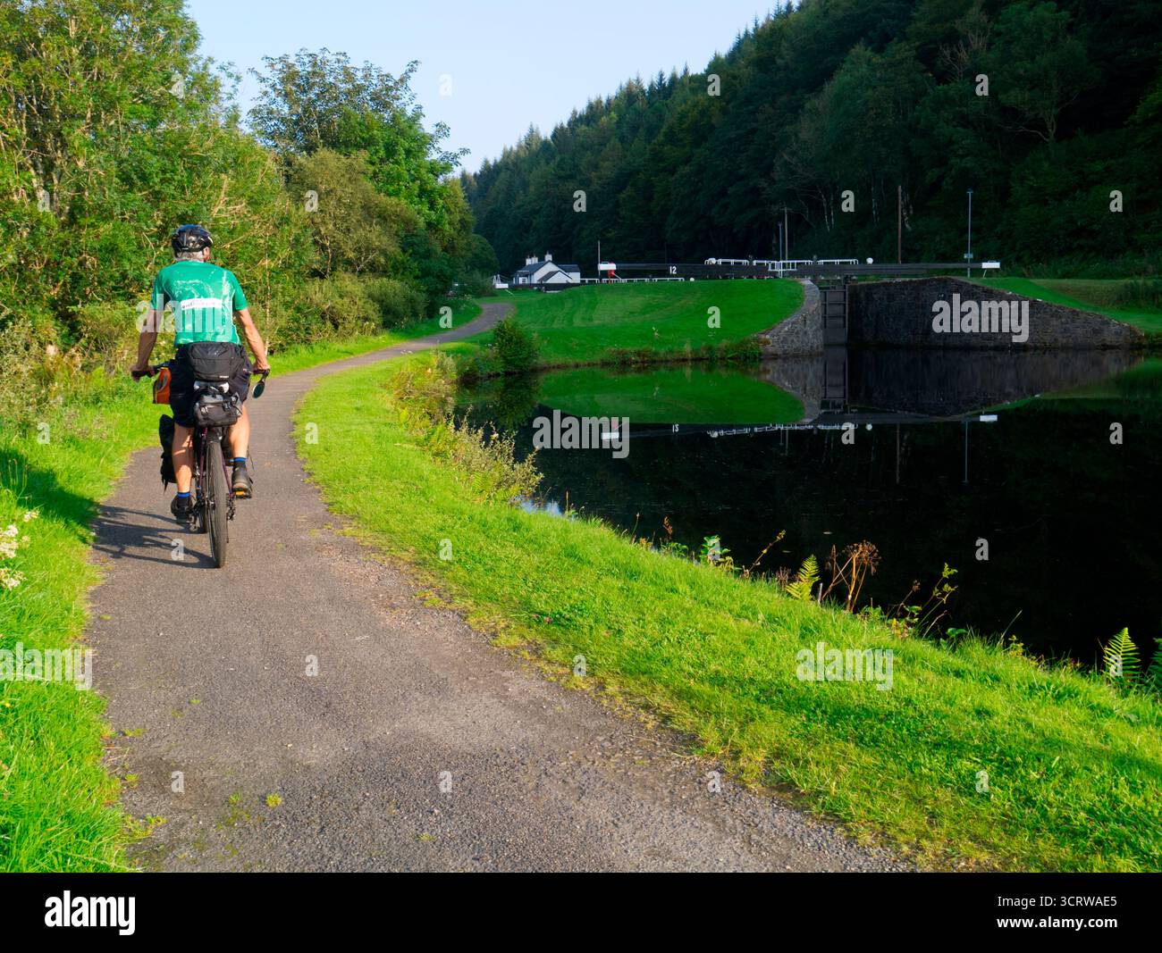 Cycle tourer on Caledonian Way next to Crinan canal, Argyll, Scotland Stock Photo