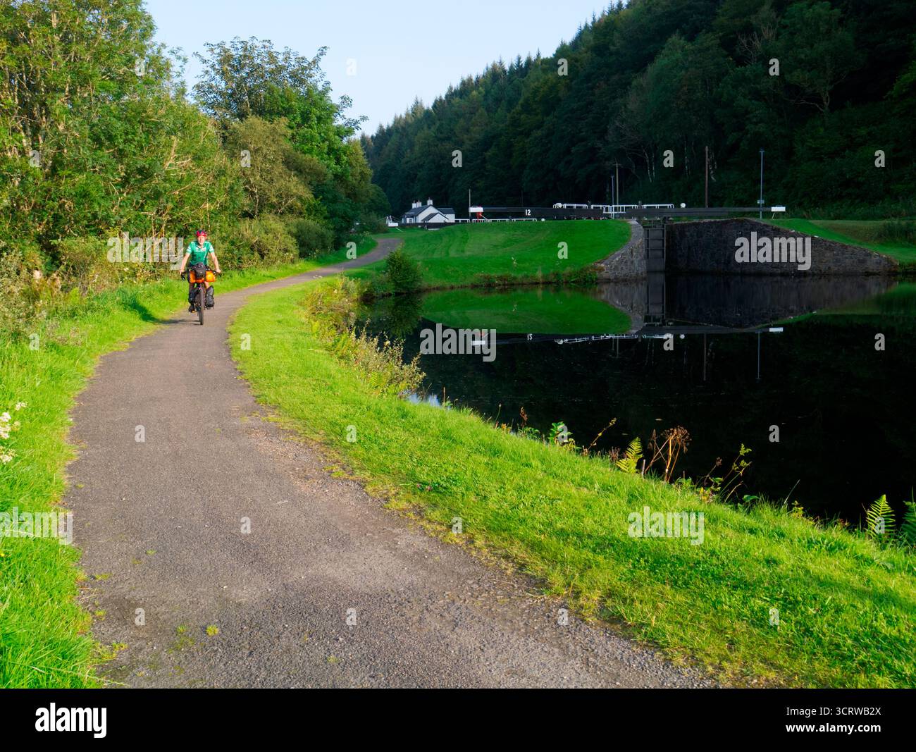 Cyclist on Caledonian Way next to Crinan canal, Argyll, Scotland Stock Photo