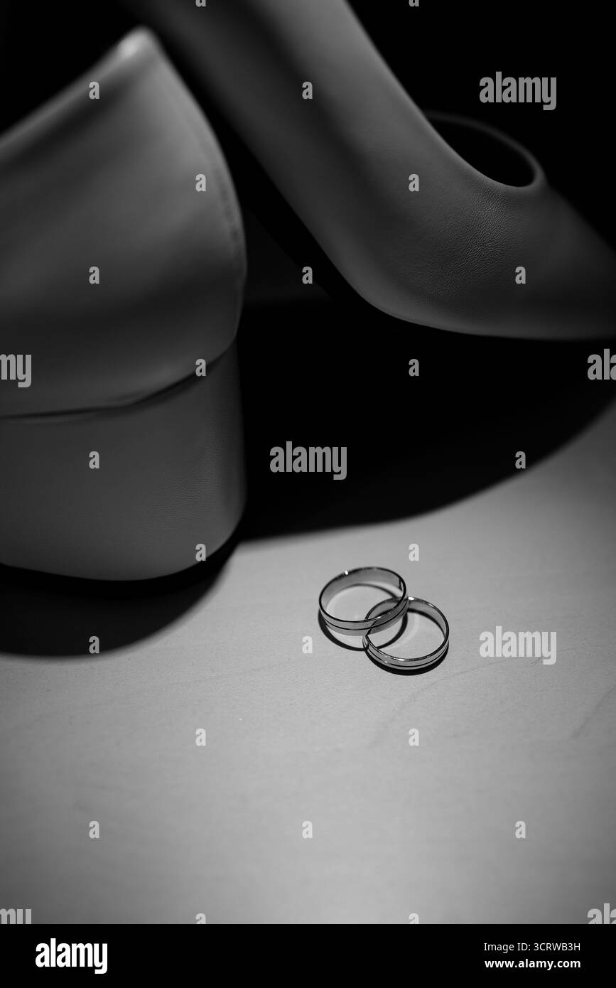 Gold Wedding Rings with White Bridal Shoes Display Stock Photo