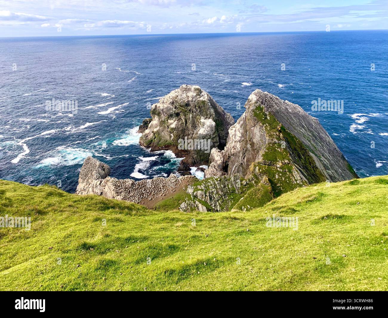 Shetland island sea water green hills birds rocks rock information spray white sky hot summer edge top walk walkers rocky land landscape walking - Smartphone Captured Stock Image