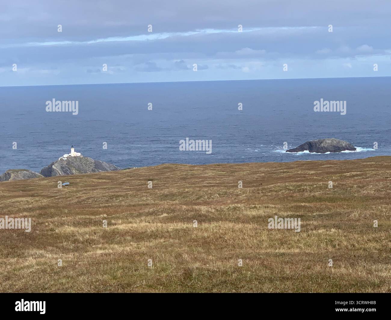Shetland island sea water green hills birds rocks rock information spray white sky hot summer edge top walk walkers rocky land landscape walking - Smartphone Captured Stock Image