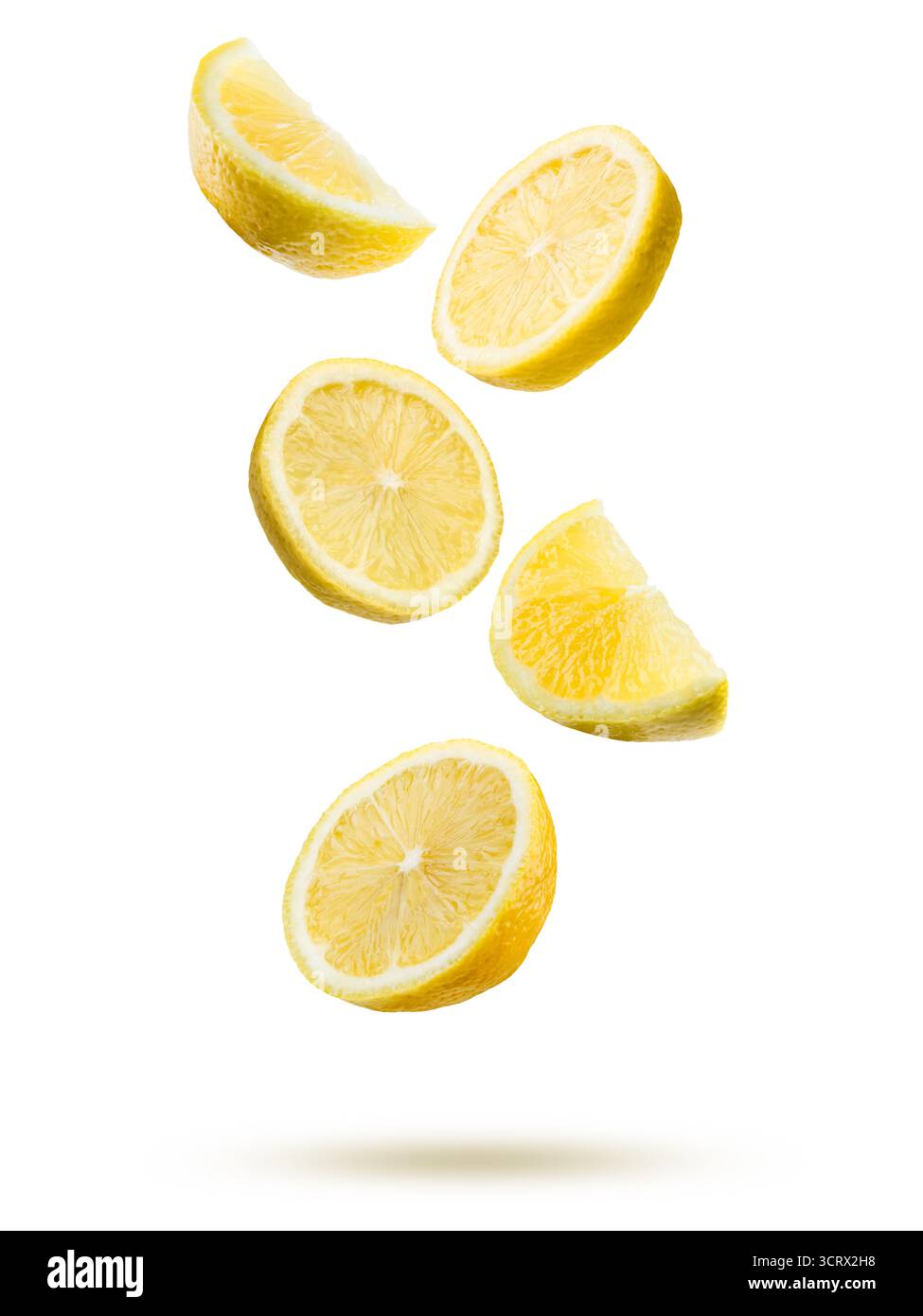 Lemon fruit slices falling on white background. Stock Photo