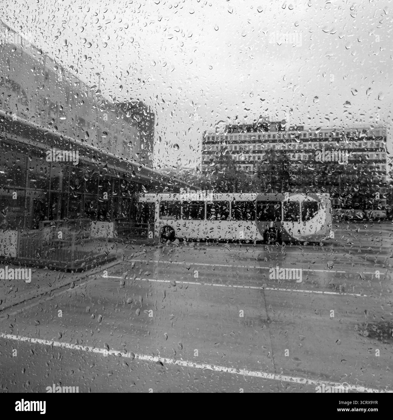 Looking through bus window to the rain at bus station in Crewe Cheshire UK Stock Photo