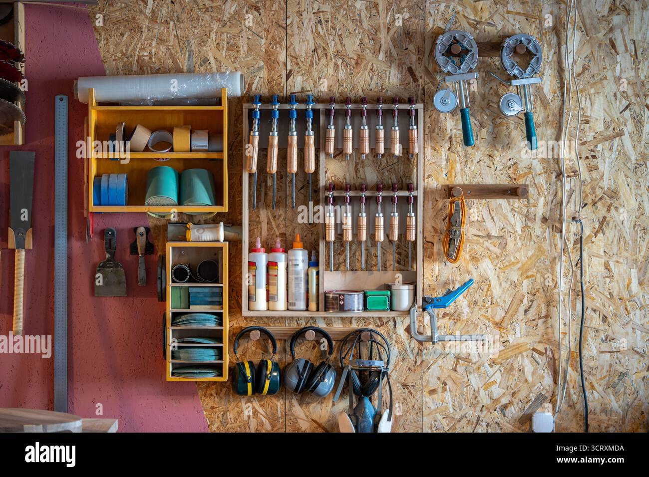 Woodworker workstation with organized tools on wall inside workshop cabinet. DIY instruments Stock Photo