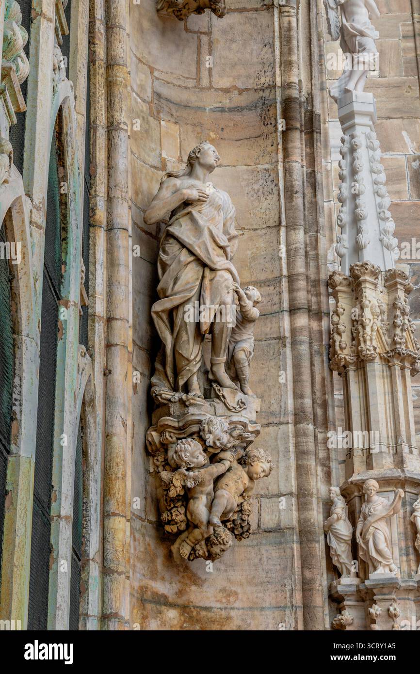 A statue on the ornately decorated facade of Milan cathedral ,Duomo di Milano ,Milan ,Italy Stock Photo