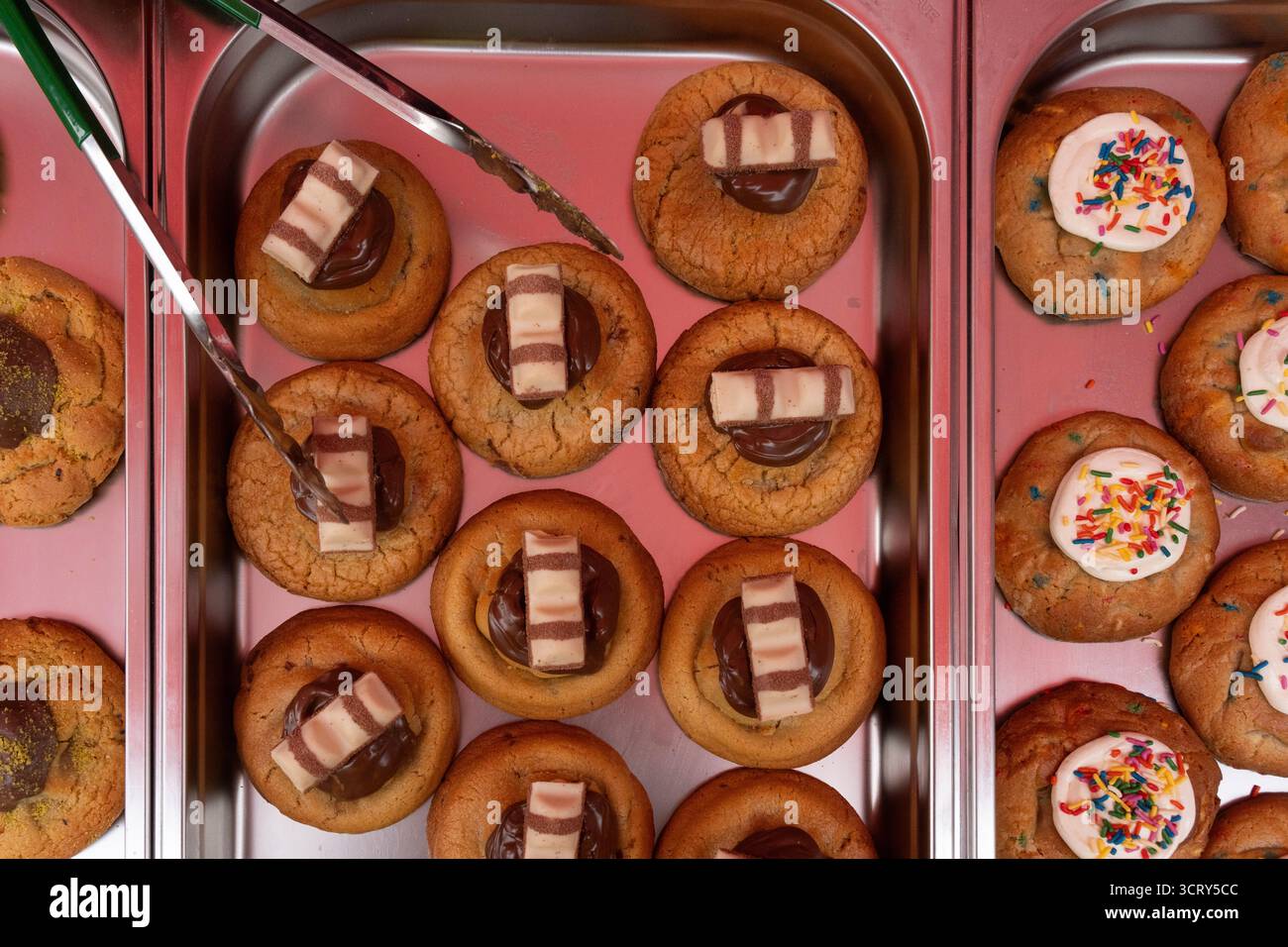Cookies with Kinder Bueno & sprinkles are prepared in a bakery in London, UK. Stock Photo