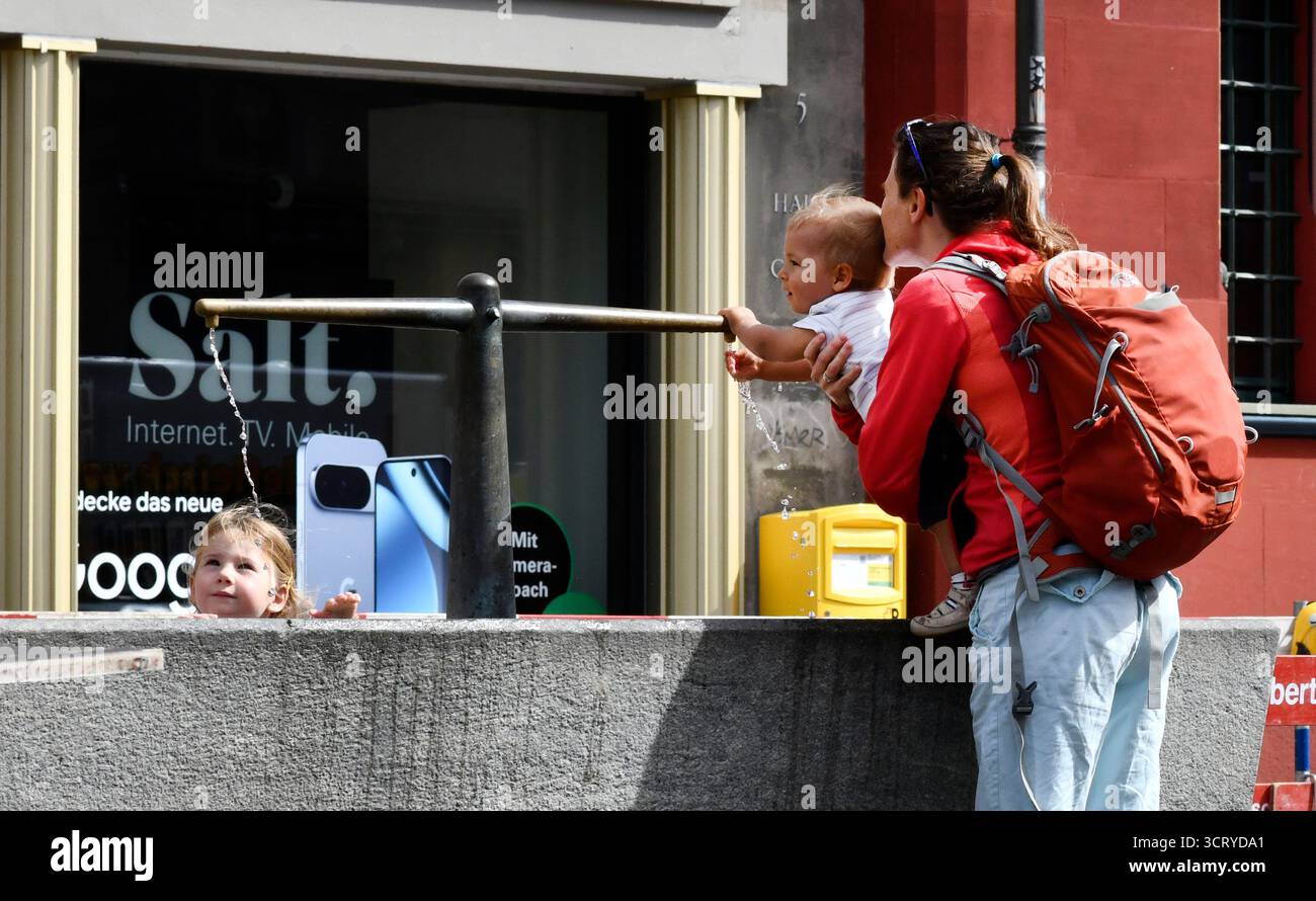 Mother and children playing with water fountain Basel  in northwestern Switzerland Stock Photo
