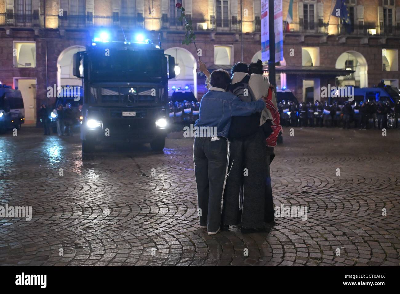 Turin Riots Demonstrators holding a rose stand in front of riot police during the ...