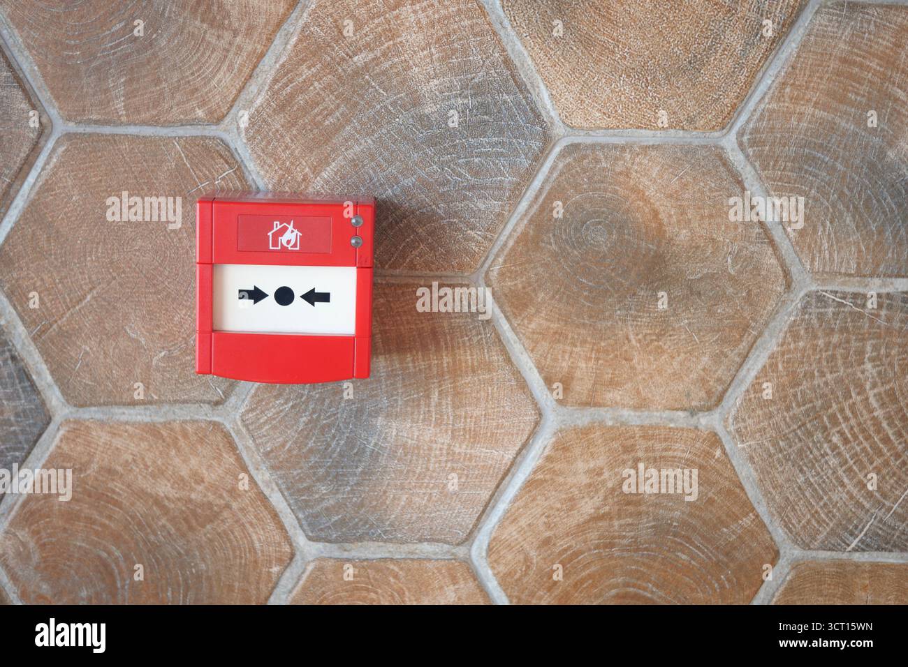 Fire alarm box mounted on hexagonal tile floor Stock Photo - Alamy