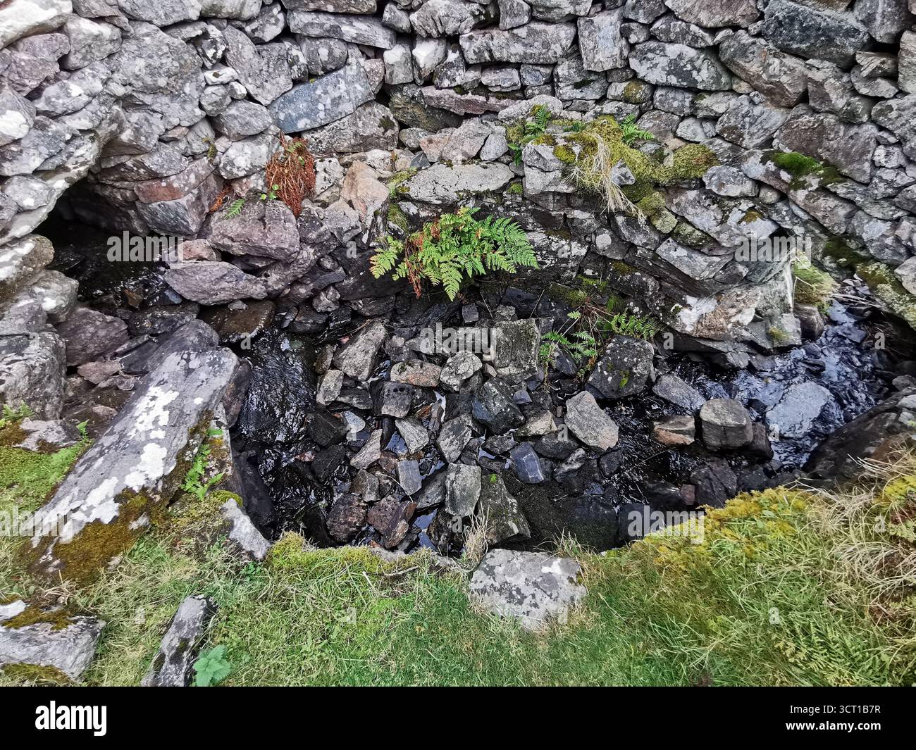 Alltanabradhan Mill, a Clearances-era ruin in the Scottish Highlands near Achmelvich on the NC500. Stone walls and old millstones still lie scattered. - Smartphone Captured Stock Image