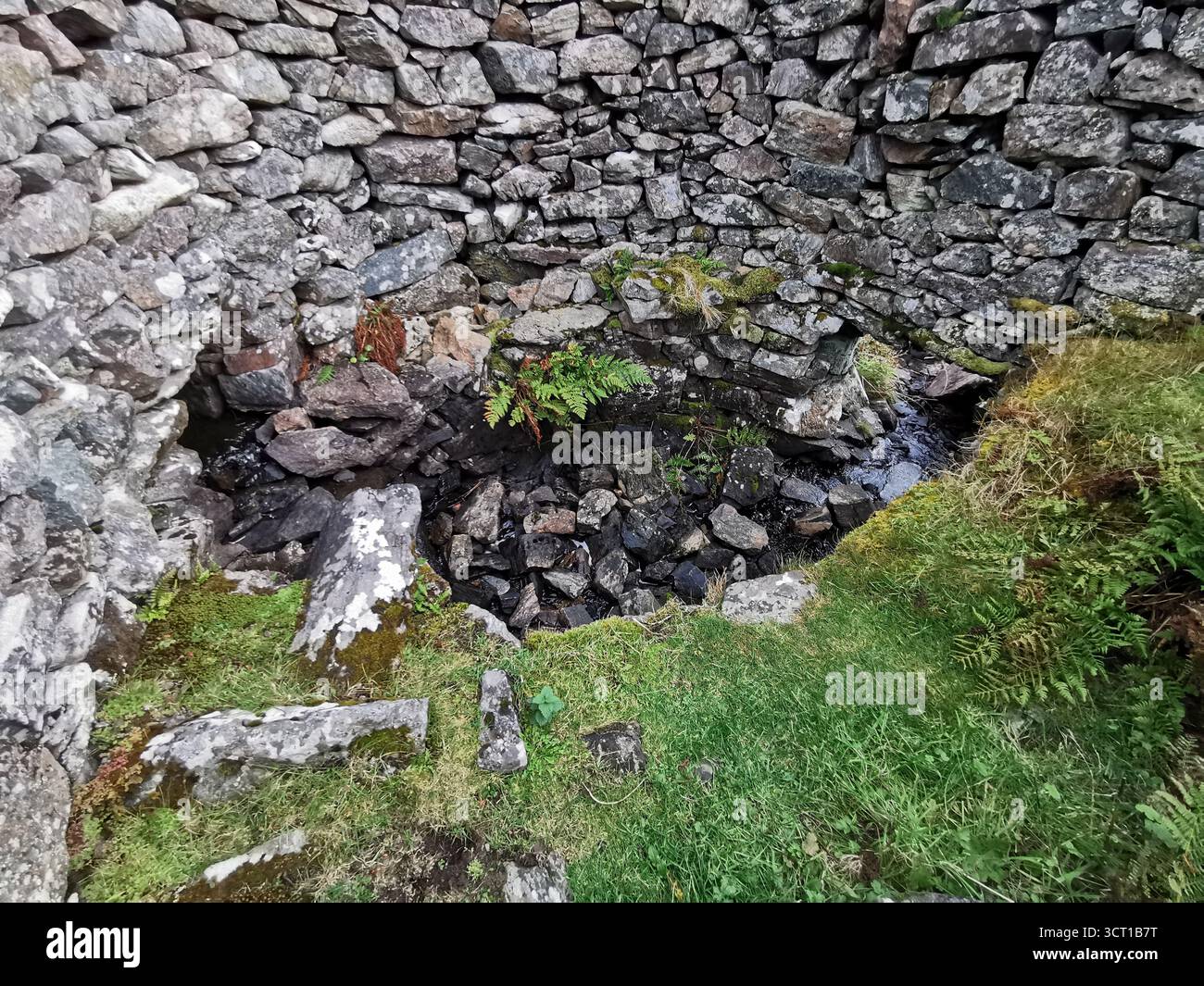 Alltanabradhan Mill, a Clearances-era ruin in the Scottish Highlands near Achmelvich on the NC500. Stone walls and old millstones still lie scattered. - Smartphone Captured Stock Image