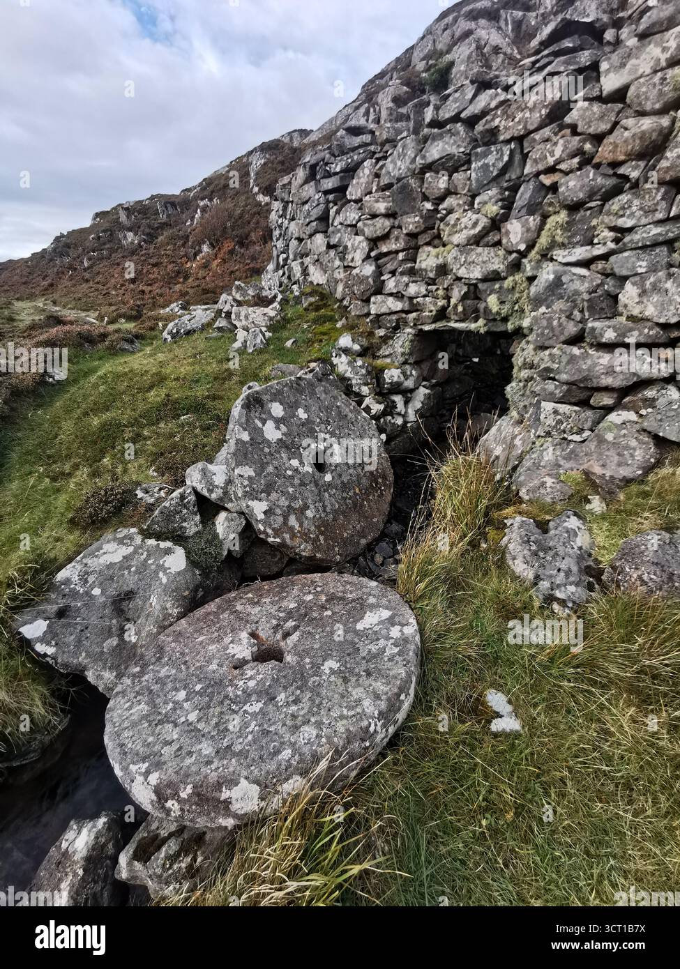 Alltanabradhan Mill, a Clearances-era ruin in the Scottish Highlands near Achmelvich on the NC500. Stone walls and old millstones still lie scattered. - Smartphone Captured Stock Image