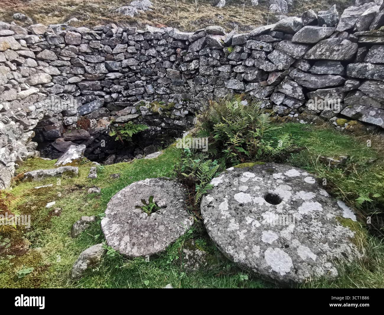 Alltanabradhan Mill, a Clearances-era ruin in the Scottish Highlands near Achmelvich on the NC500. Stone walls and old millstones still lie scattered. - Smartphone Captured Stock Image
