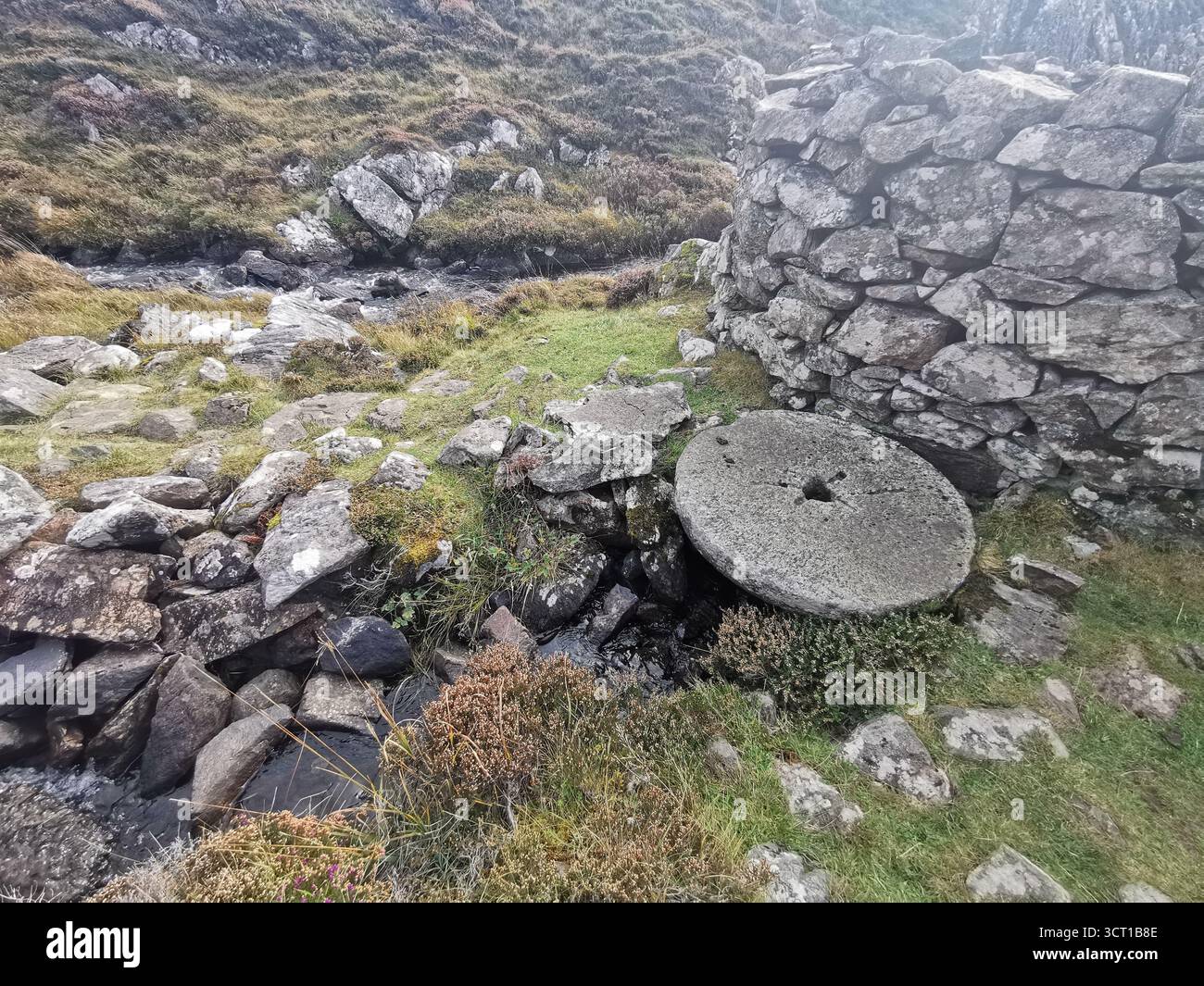 Alltanabradhan Mill, a Clearances-era ruin in the Scottish Highlands near Achmelvich on the NC500. Stone walls and old millstones still lie scattered. - Smartphone Captured Stock Image