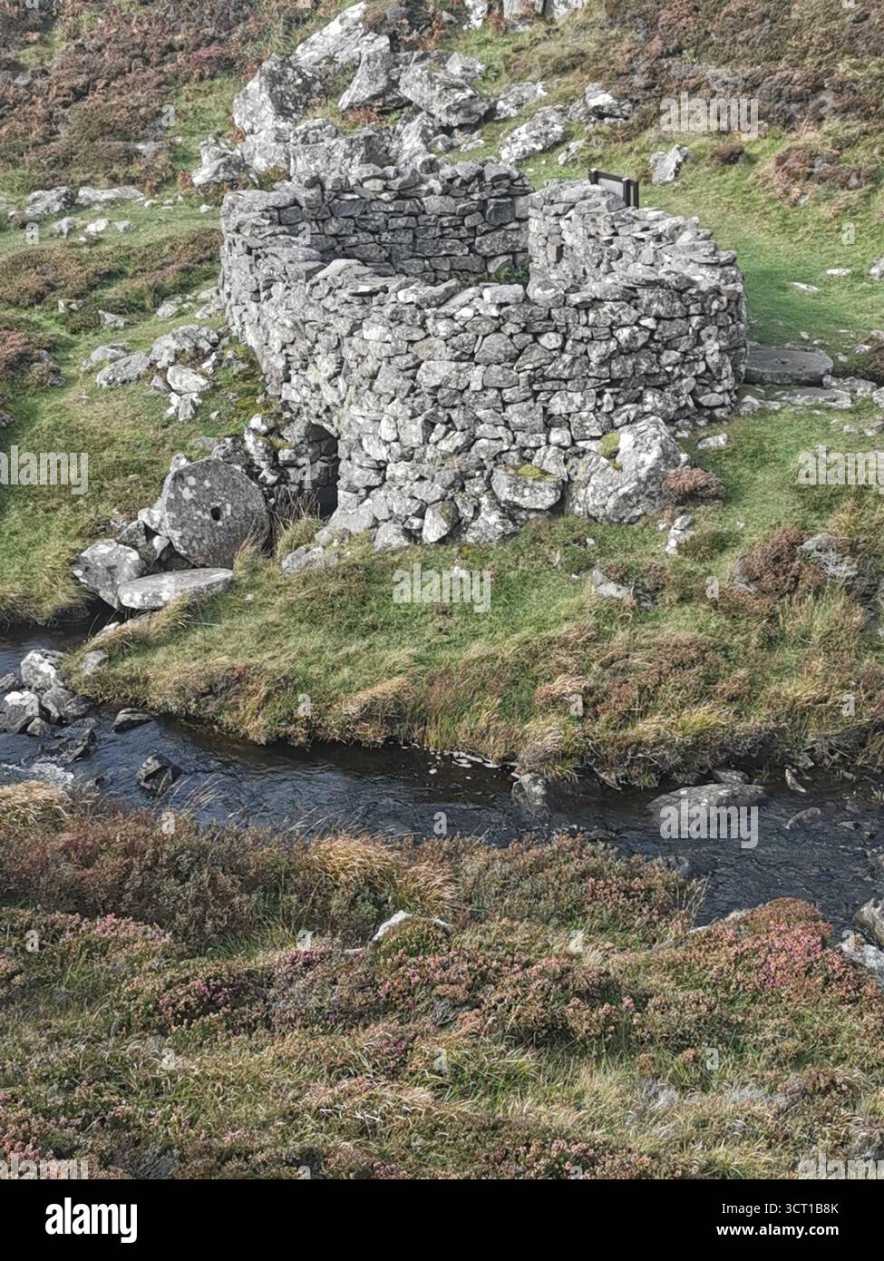 Alltanabradhan Mill, a Clearances-era ruin in the Scottish Highlands near Achmelvich on the NC500. Stone walls and old millstones still lie scattered. - Smartphone Captured Stock Image