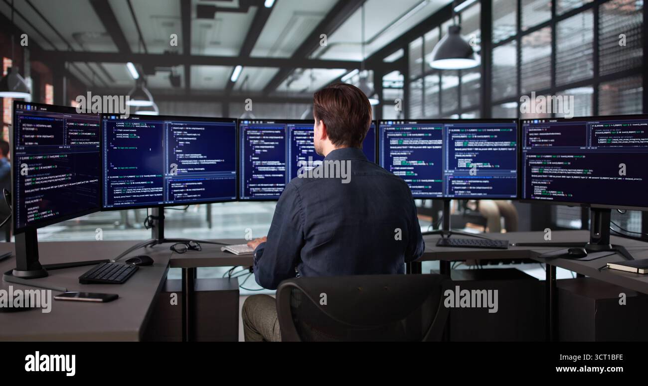 Elderly Man In Office Developing Software On Desktop Computer Screen Stock Photo