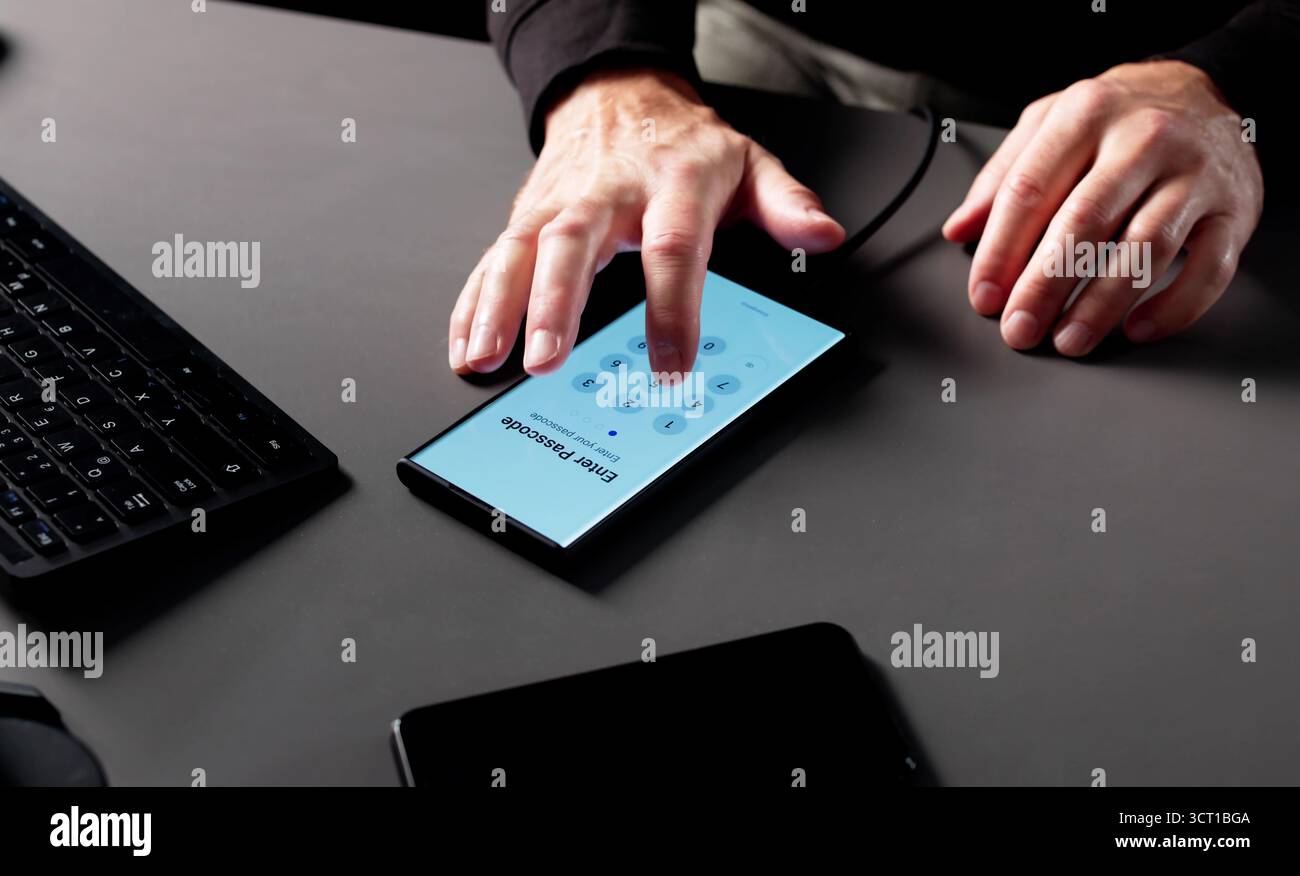 Senior Man Stealing Data From Smartphone Using Hacking Software Anonymously. Stock Photo