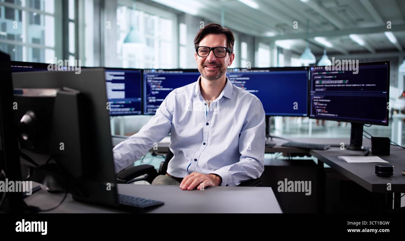 Senior Programmer Working On Web Development Code At His Desk Office Stock Photo