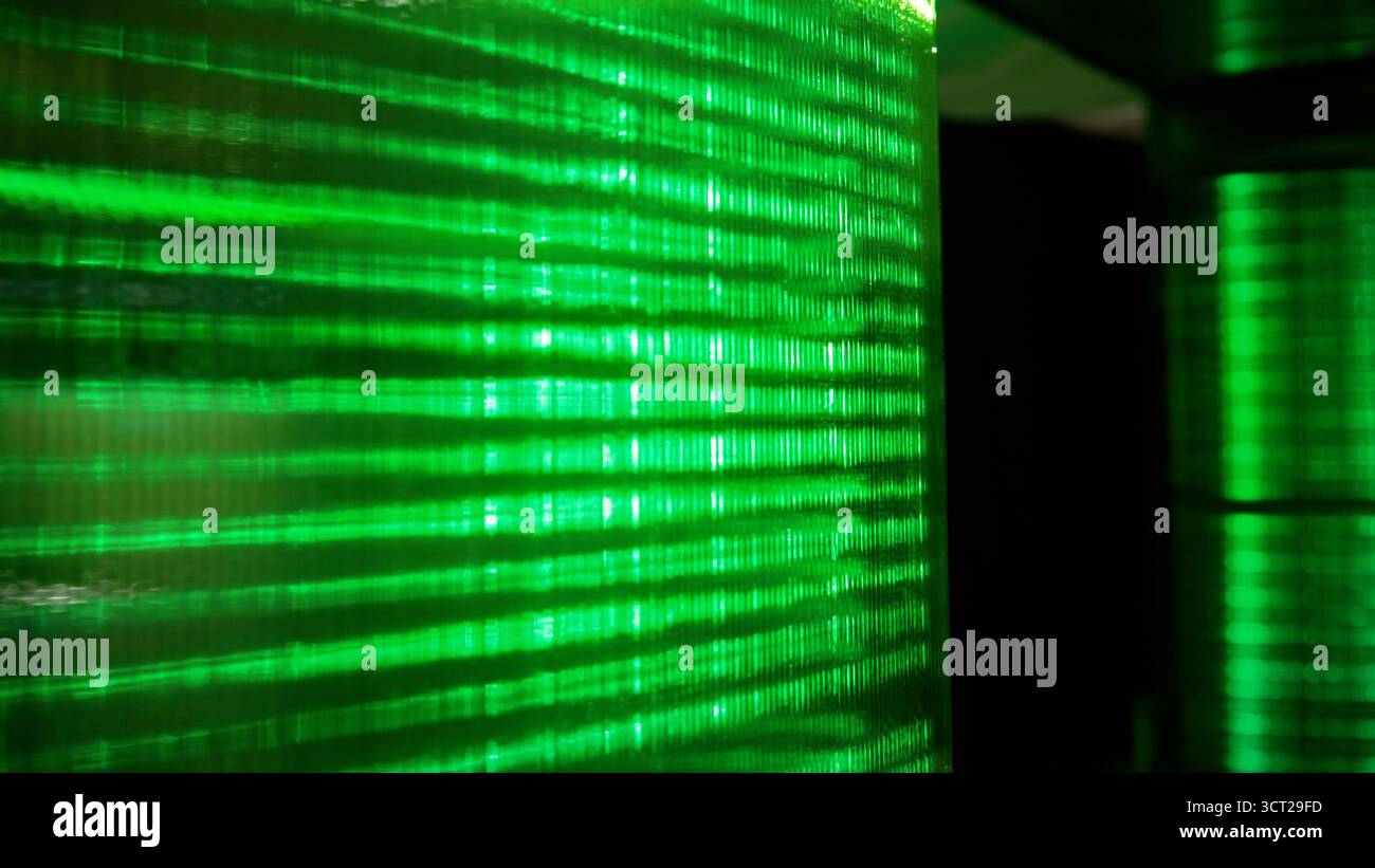 Green glowing lines creating abstract patterns and digital code representing data transferring and cyber security concepts Stock Photo
