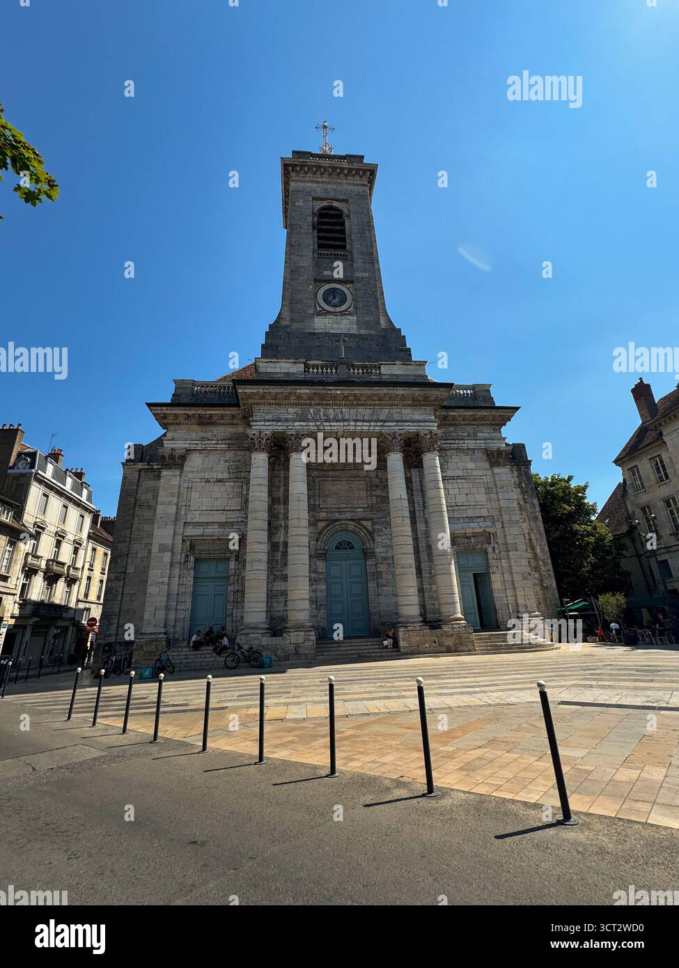 Front view of Saint-Pierre Church in Besançon, France, featuring a neoclassical stone facade, blue doors and a bell tower under a clear sky. - Smartphone Captured Stock Image