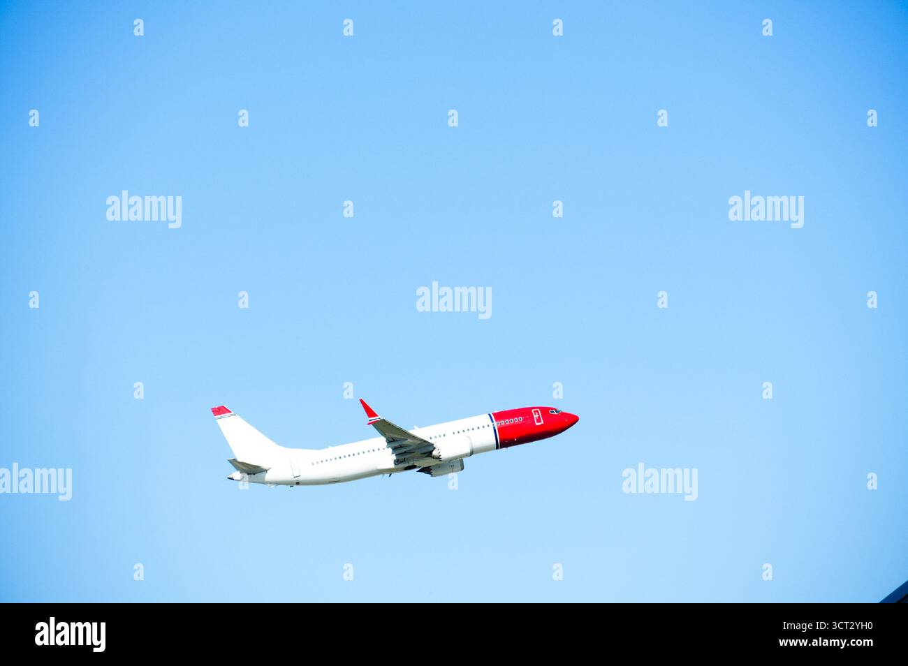 Airplane in the blue sky. Large airplane during takeoff. Stock Photo