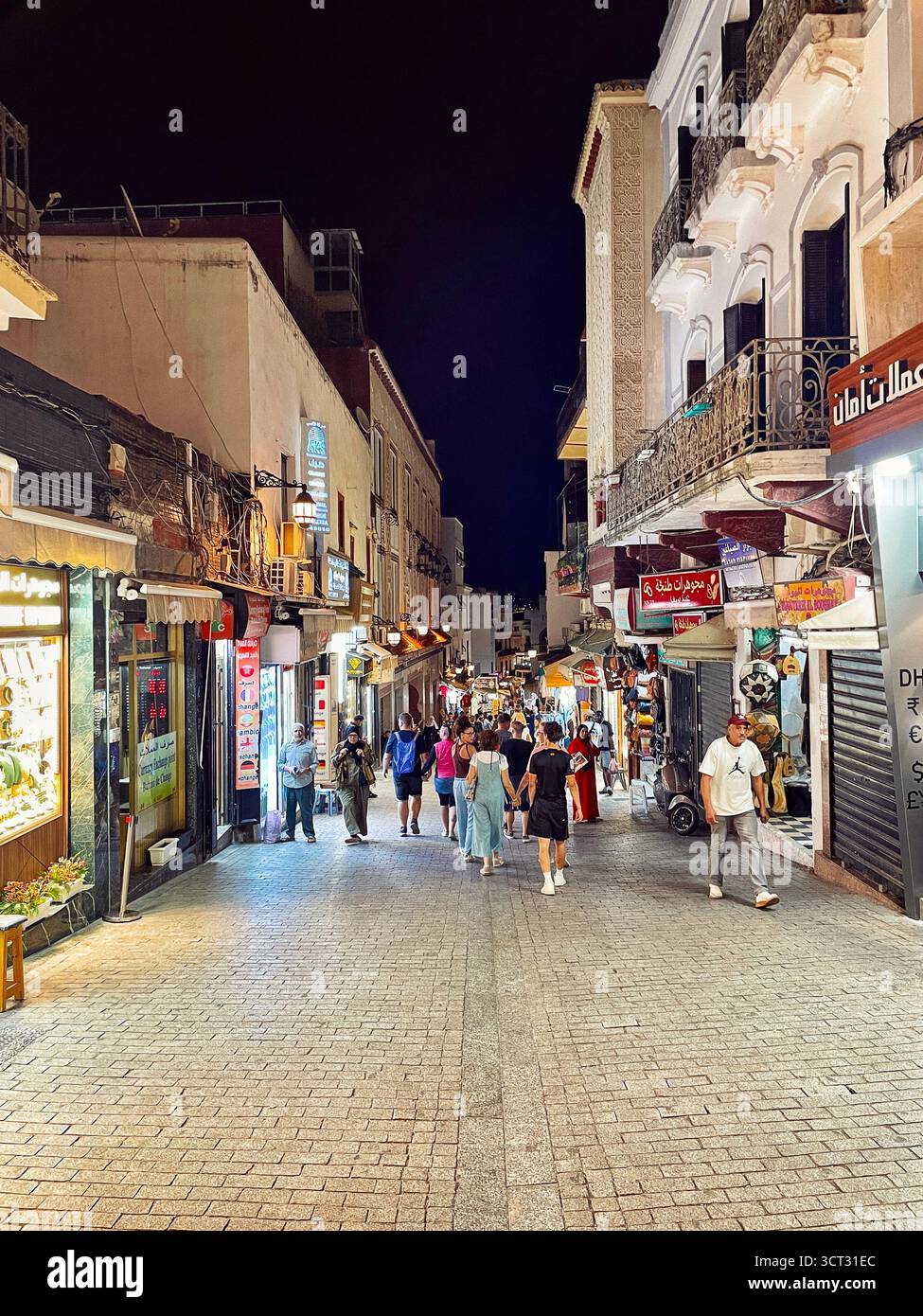 "Nighttime pedestrian street with shops, cobblestones, and warm lighting in Tangier, Morocco — October 3, 2025." Stock Photo