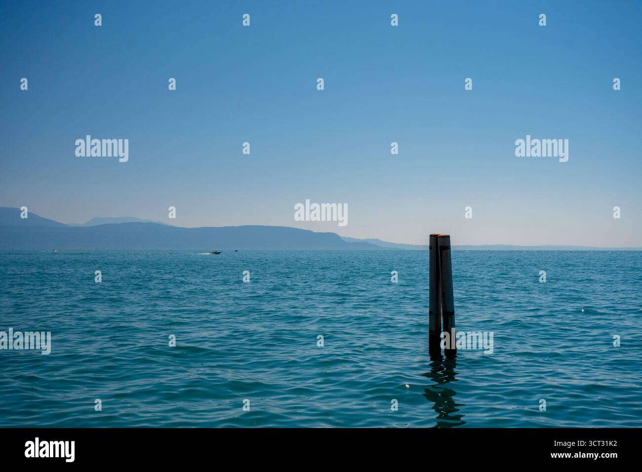 Shimmering blue water of Lake Garda seen from a boat in the lake in the summer Stock Photo