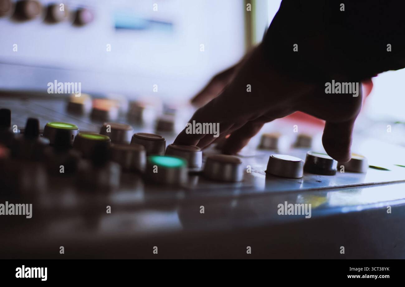 The hand on the button. Pressing the buttons on the remote control. Stock Photo